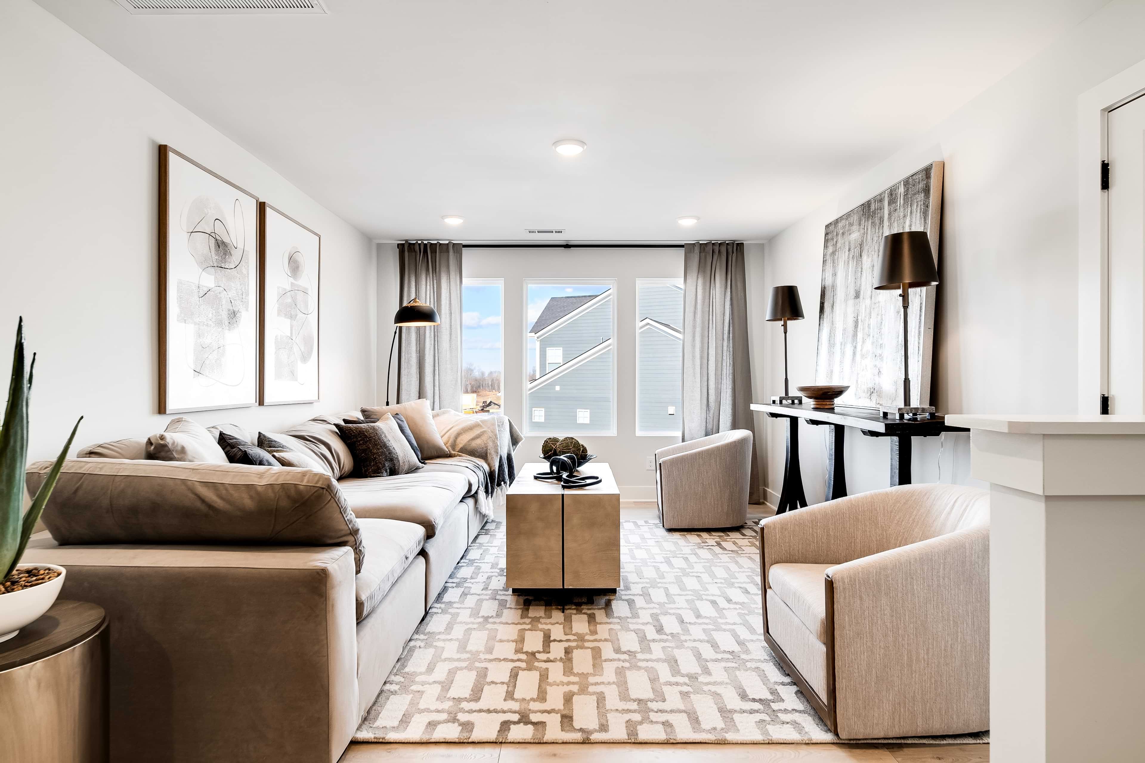 Luxurious Living Room Design in Richvale Estates with Modern Elegance Luxurious living room in Richvale Estates featuring modern decor, large windows, elegant furniture, and subtle grey tones.