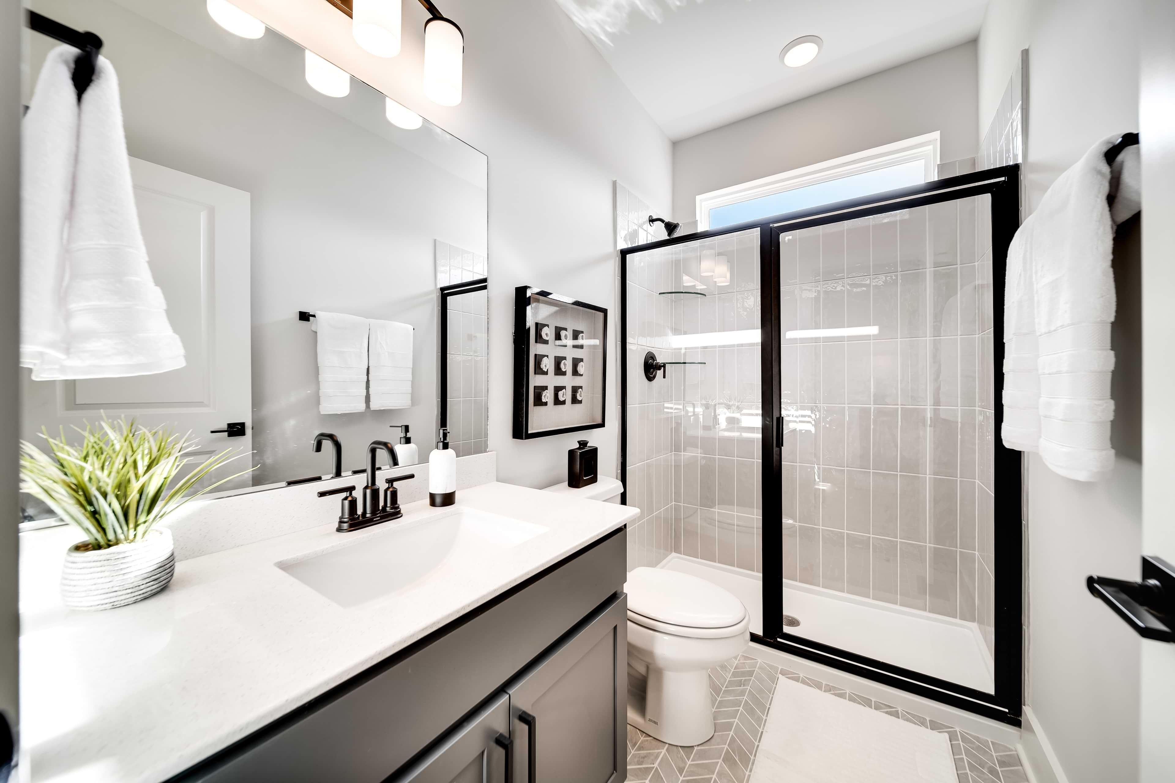 Luxury Bathroom Design in Richvale Estates with Black Fixtures Modern bathroom with black fixtures, glass shower, geometric tiles in Richvale Estates. Minimalist design.