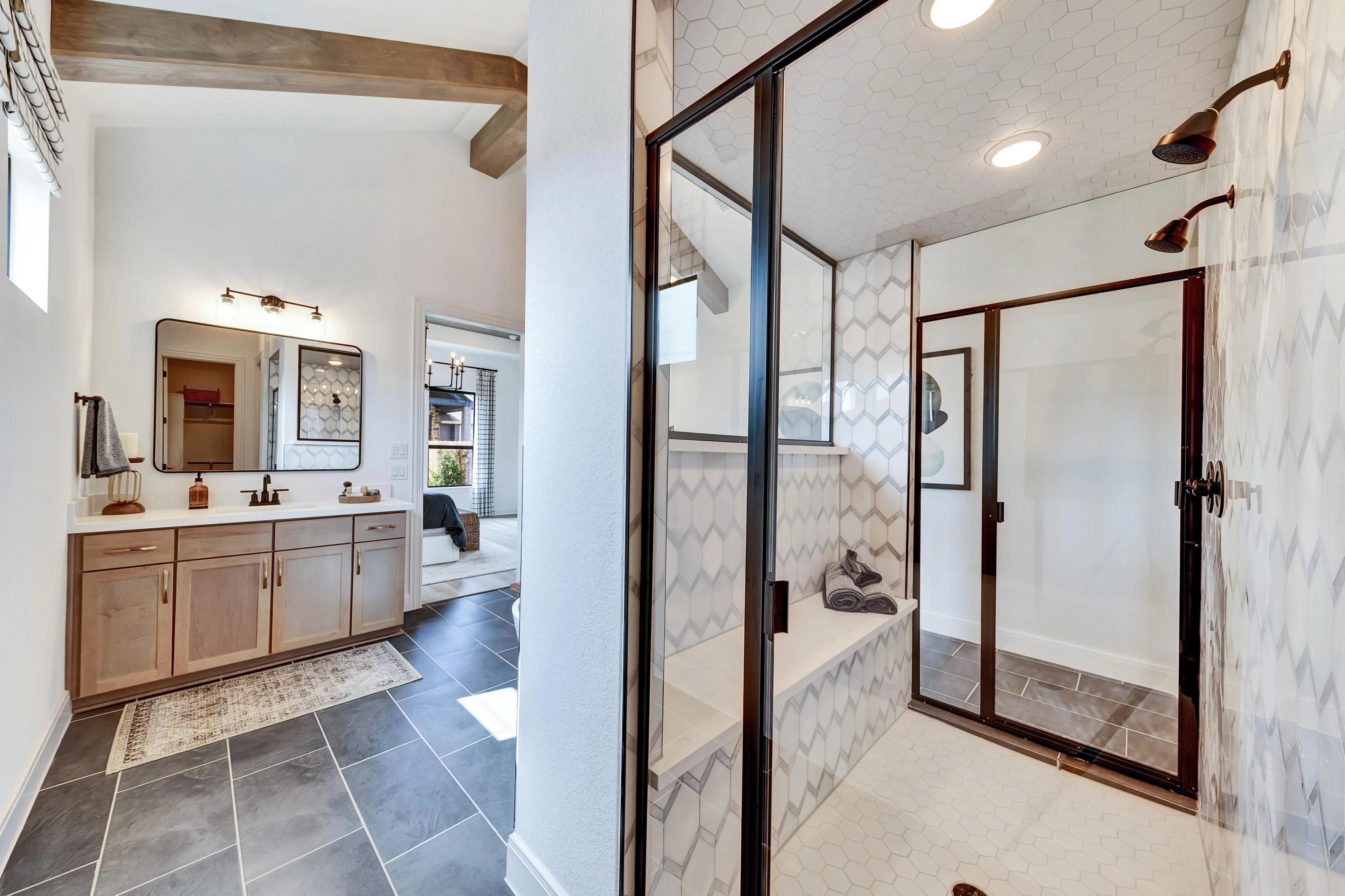 Elegant Bathroom with Hexagonal Tiles in Hawkes Landing Property Luxurious bathroom with hexagonal tile design, glass shower, and wood beams in Hawkes Landing home.