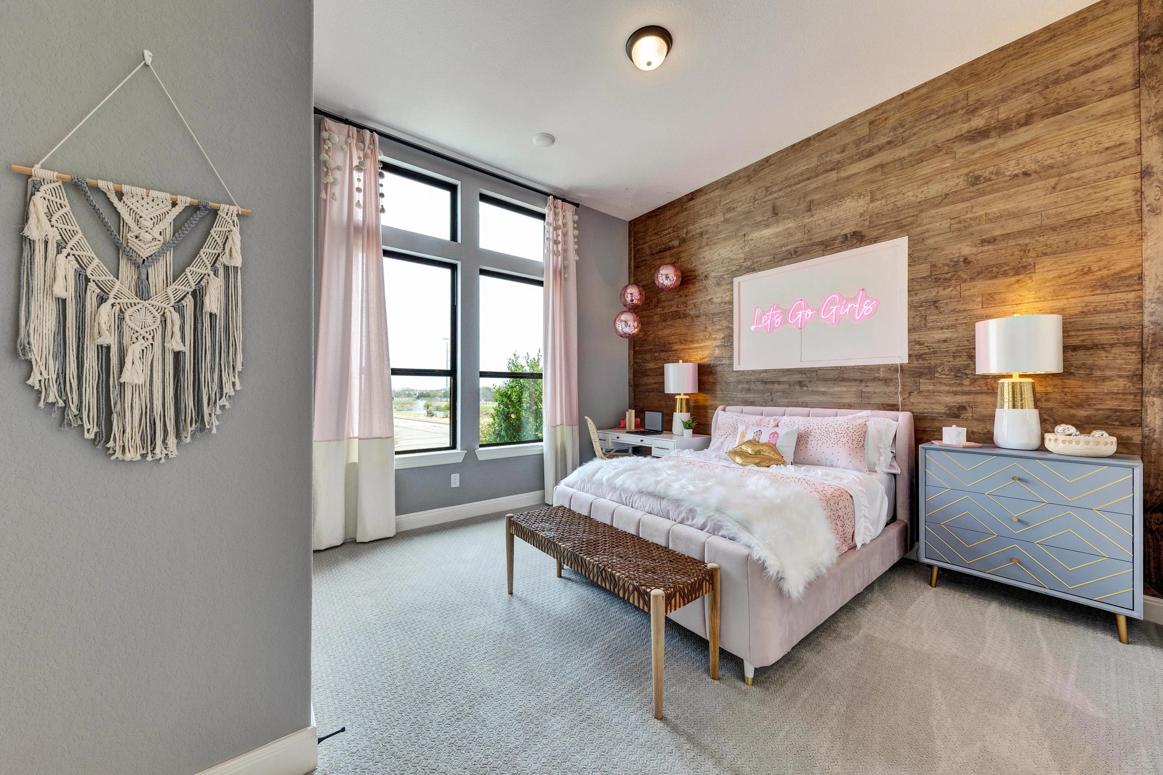 Modern Bedroom with Wood Accent Wall in Hawkes Landing Stylish bedroom with wood accent wall, modern furniture, and large windows in Hawkes Landing.