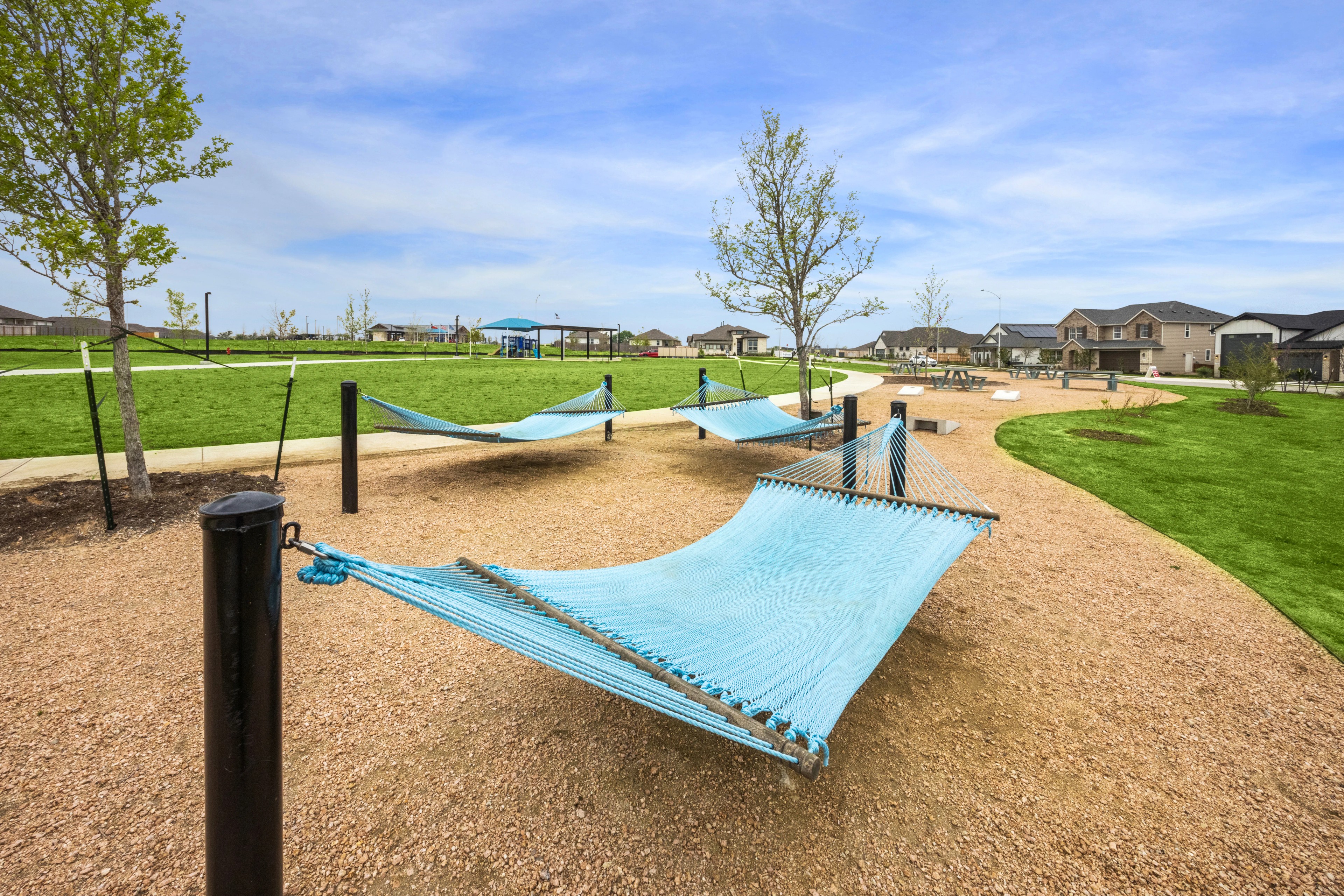 Hammocks in Carillon Community Park with Green Spaces Hammocks in Carillon community park with green spaces, walkways, and nearby houses create a serene suburban setting.