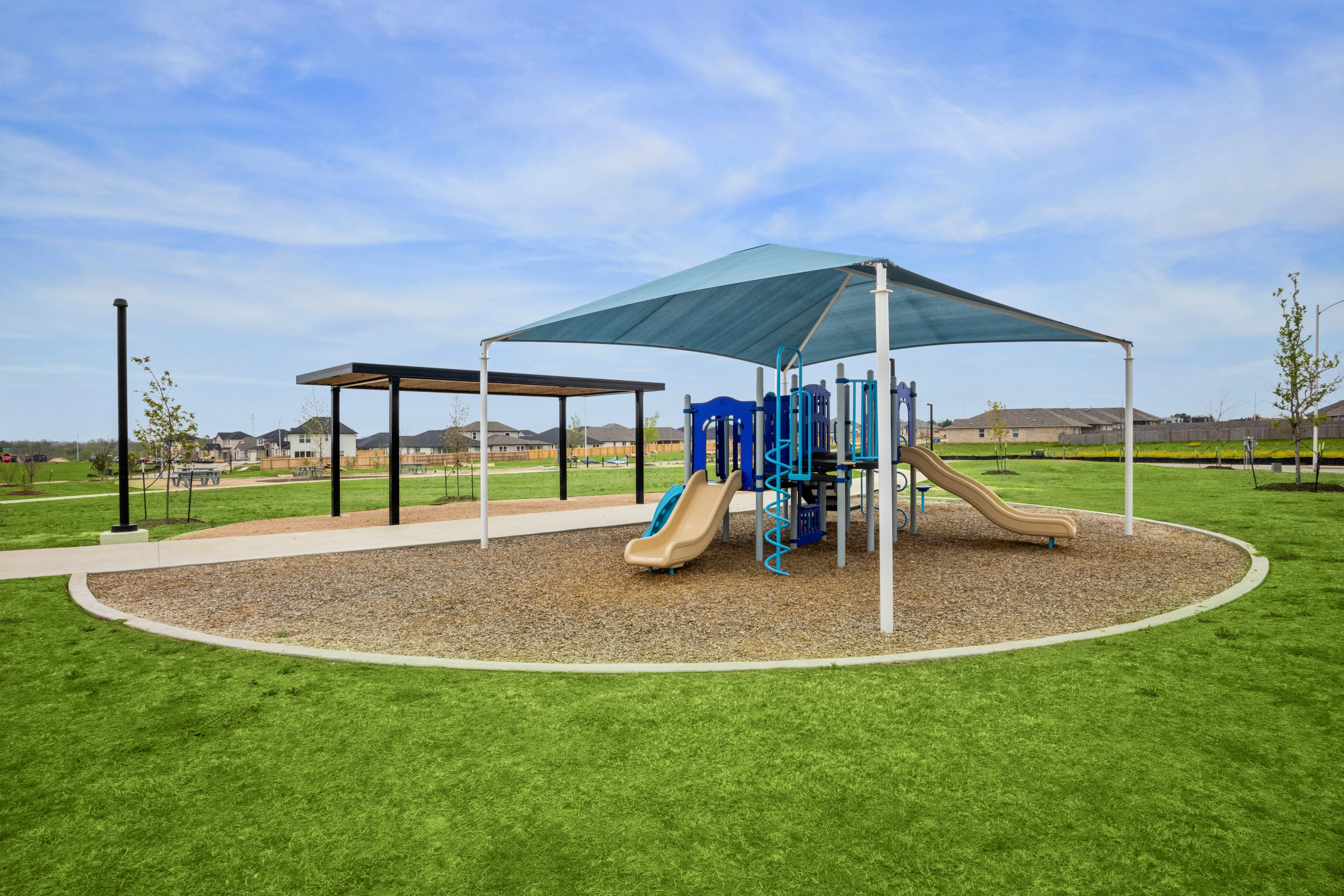Carillon Community Playground with Blue Shade and Slides Modern playground with blue shades and slides in Carillon community park, surrounded by well-maintained green space.
