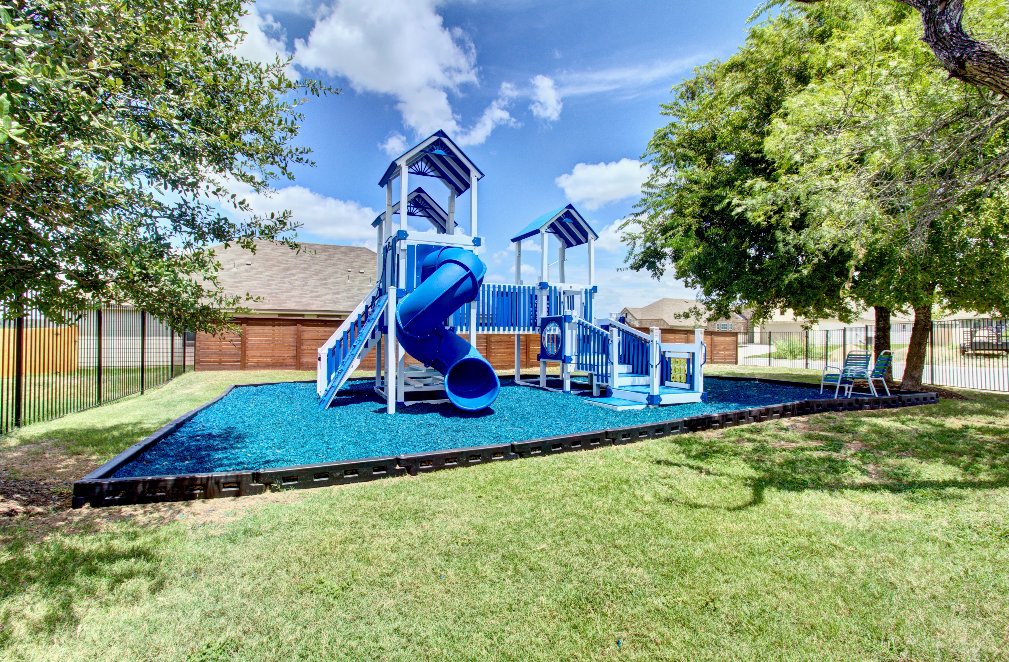 Blue Playground Structures at Cloud Country Park, Suburban Community Blue playground with slides and climbing structures, fenced, in a sunny suburban park, Cloud Country.