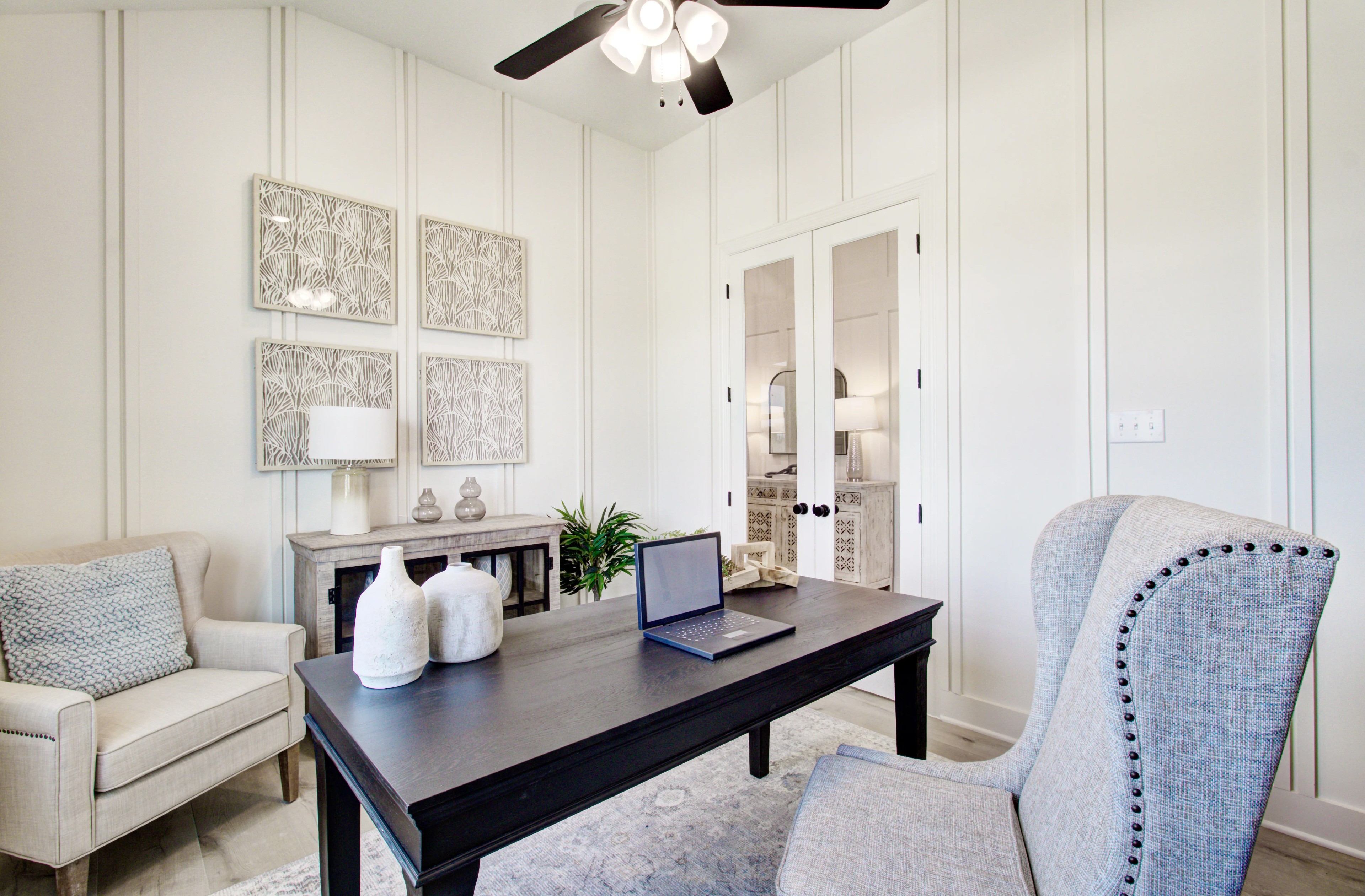 Luxurious Home Office Design in Veranda Community, USA Elegant home office with black desk, white paneled walls, and ornate decor in Veranda community, USA.