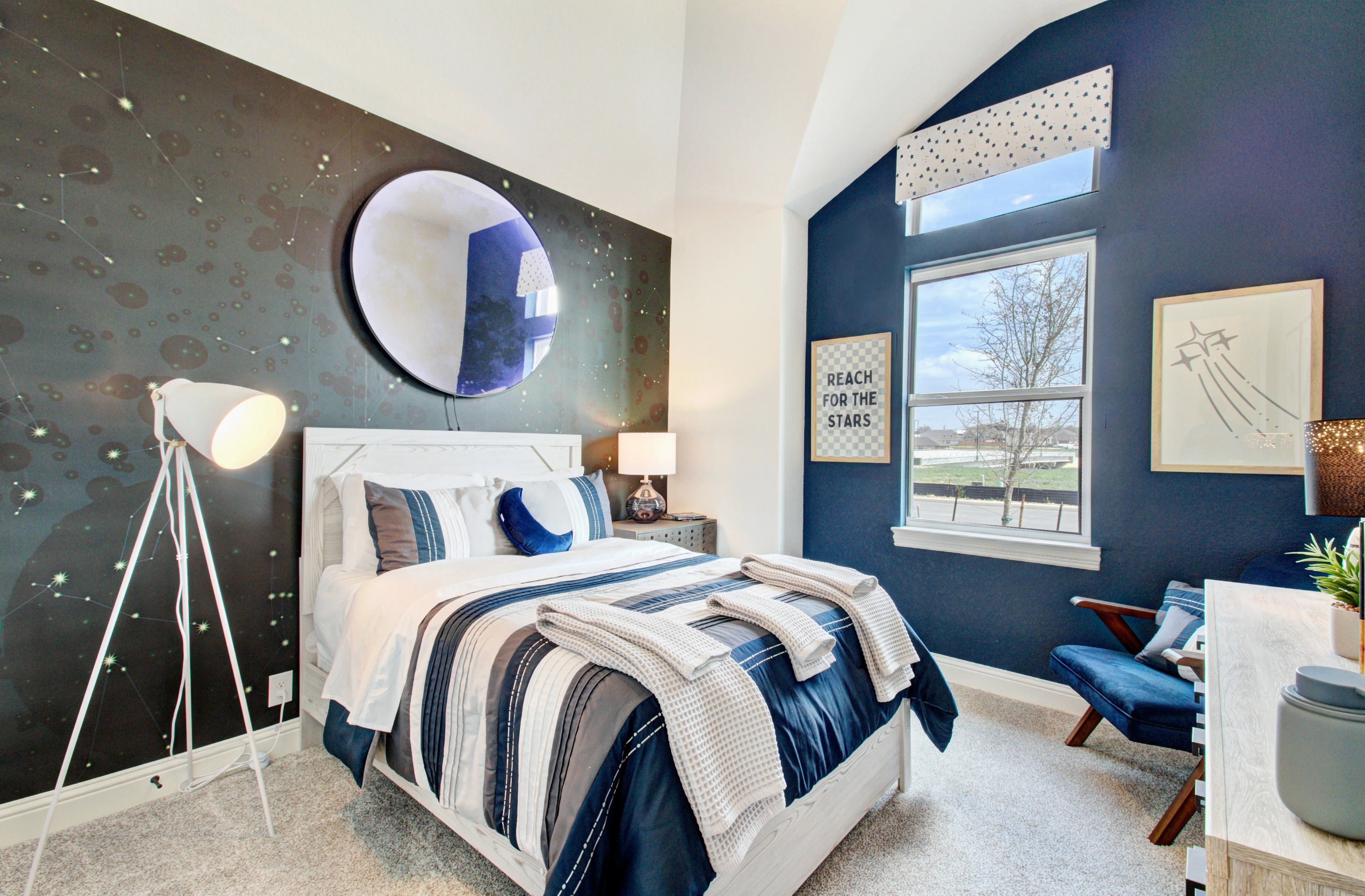 Stylish Bedroom with Celestial Theme in Veranda Community Modern bedroom with celestial wallpaper, plush bedding, and large window in Veranda community.