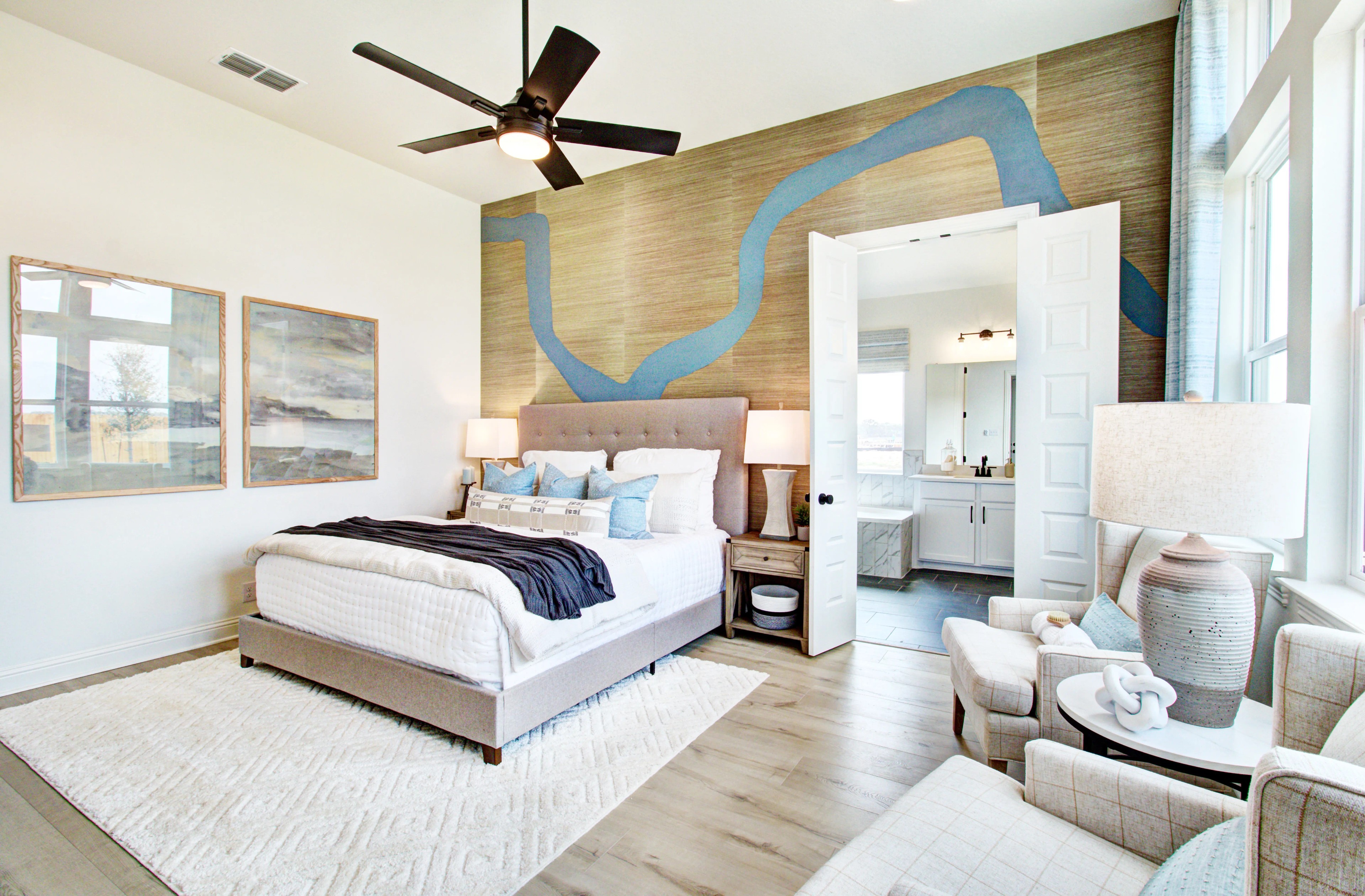 Modern Bedroom with Elegant Design in Veranda Community Luxurious bedroom with abstract wall art, modern fan, and upholstered bed in Veranda community home.