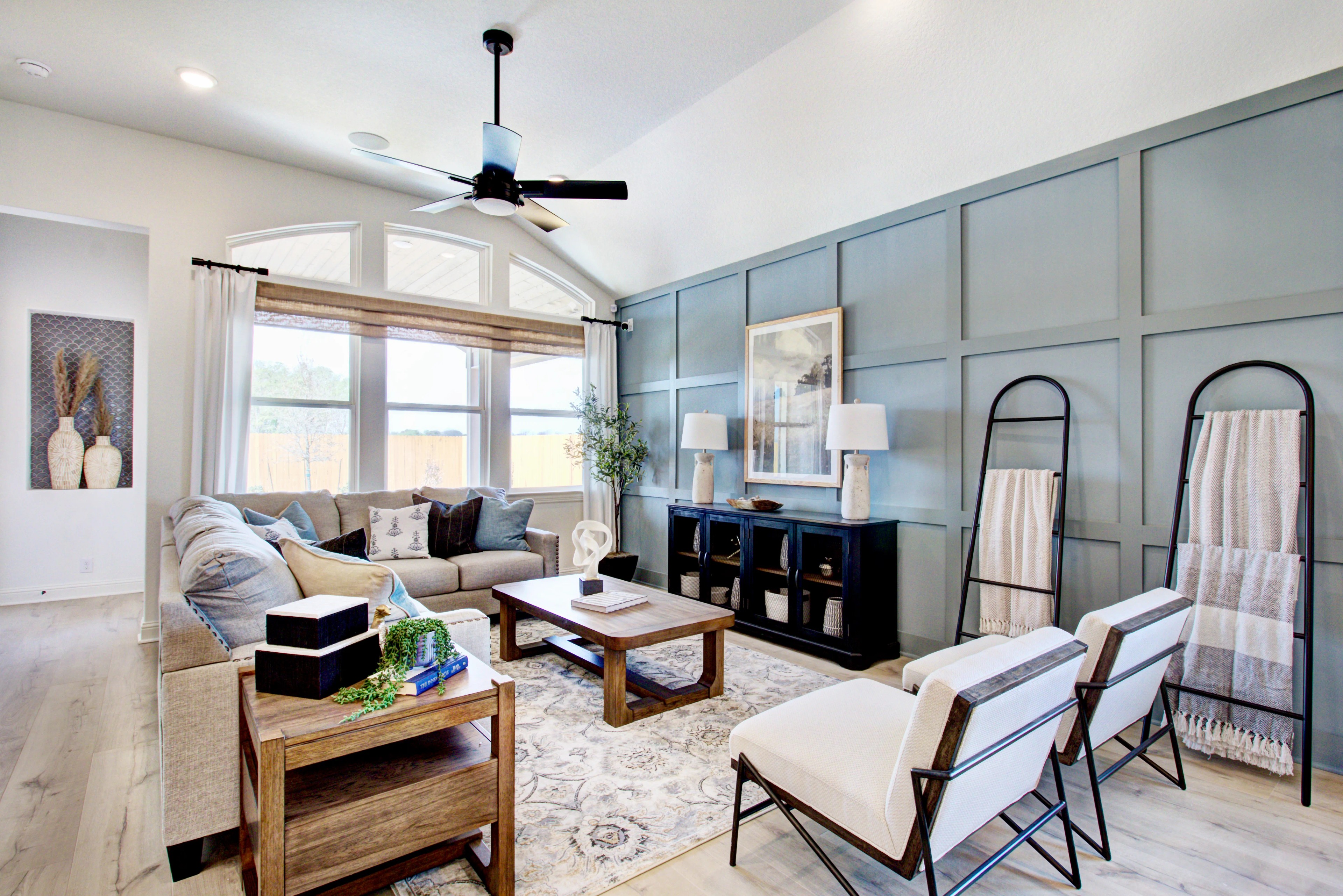 Elegant Living Room with Vaulted Ceiling in Veranda Community Luxury living room with arched windows, vaulted ceiling, elegant wainscoting, Veranda community.