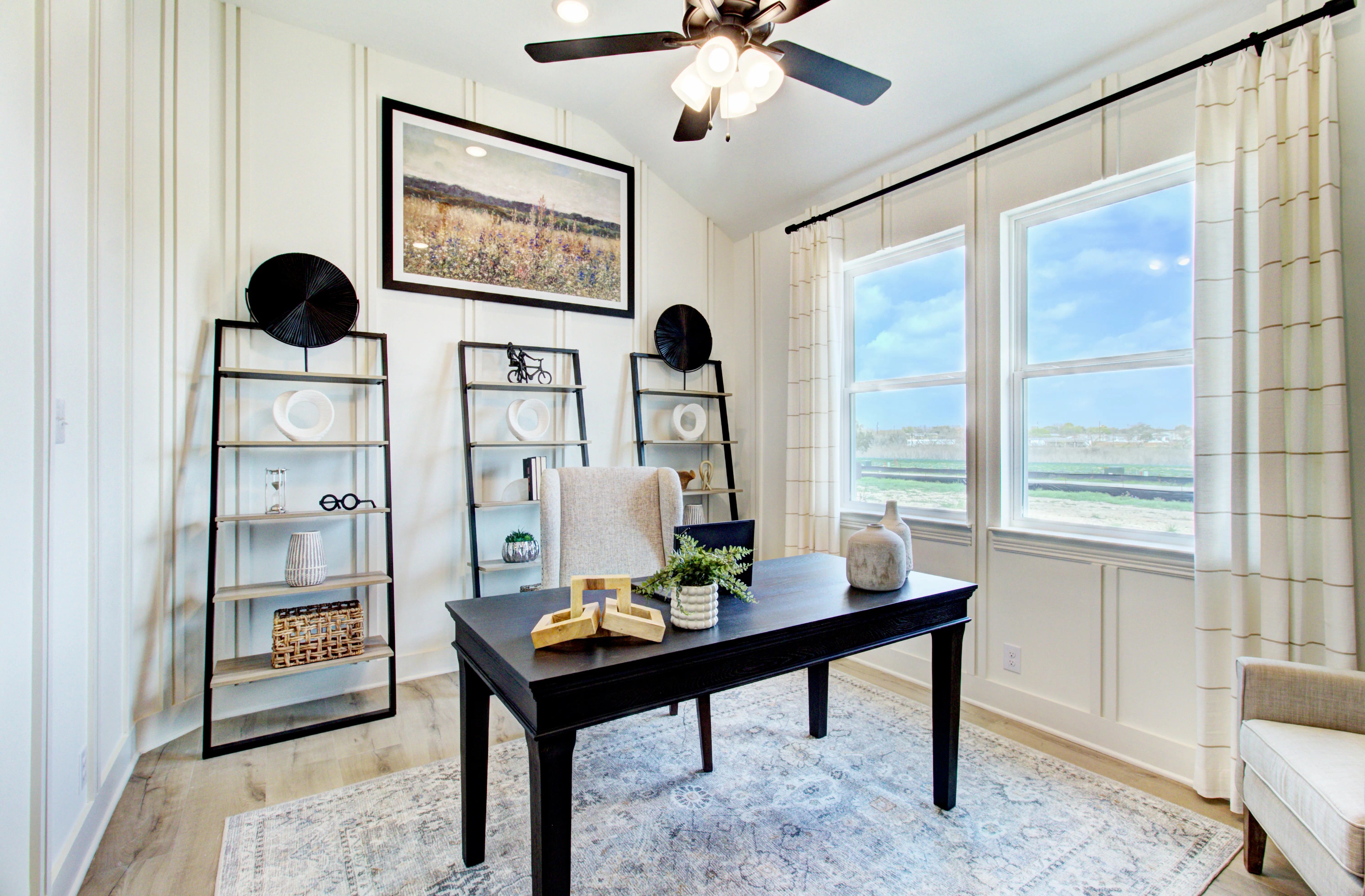 Luxury Home Office with Modern Decor in Veranda Community Elegant home office in Veranda with large windows, chic decor, black desk, and modern shelves.