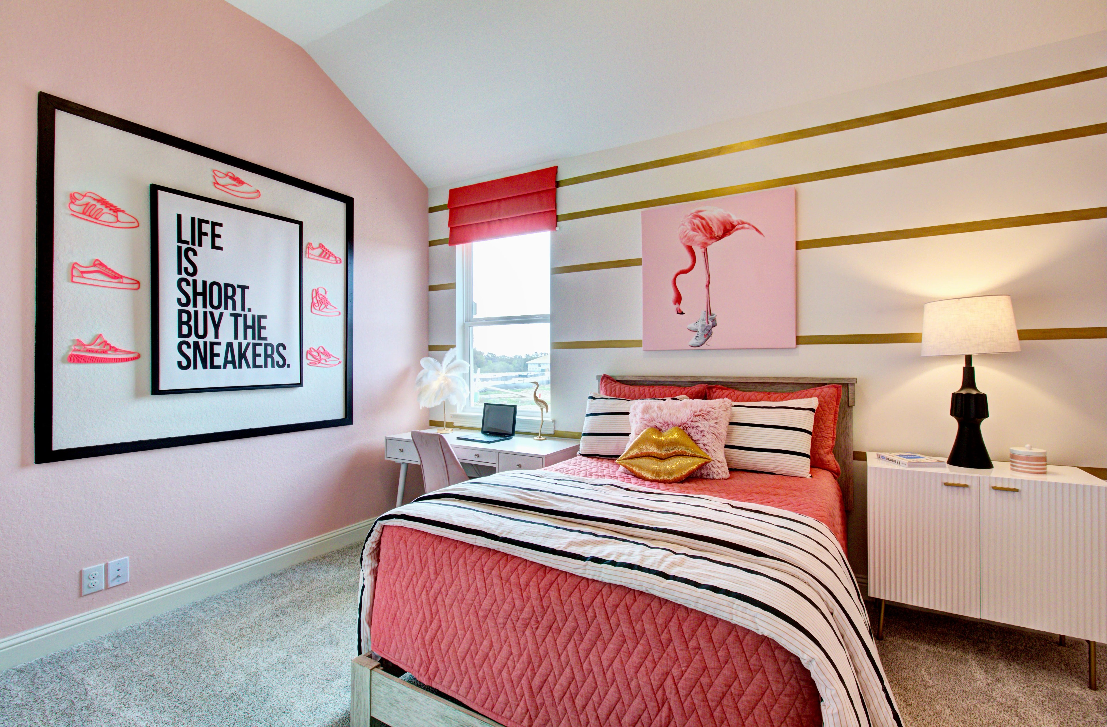 Modern Bedroom Design with Pink Accents in Veranda Community Bedroom with pink decor, framed sneaker art, modern furniture, Veranda community setting.