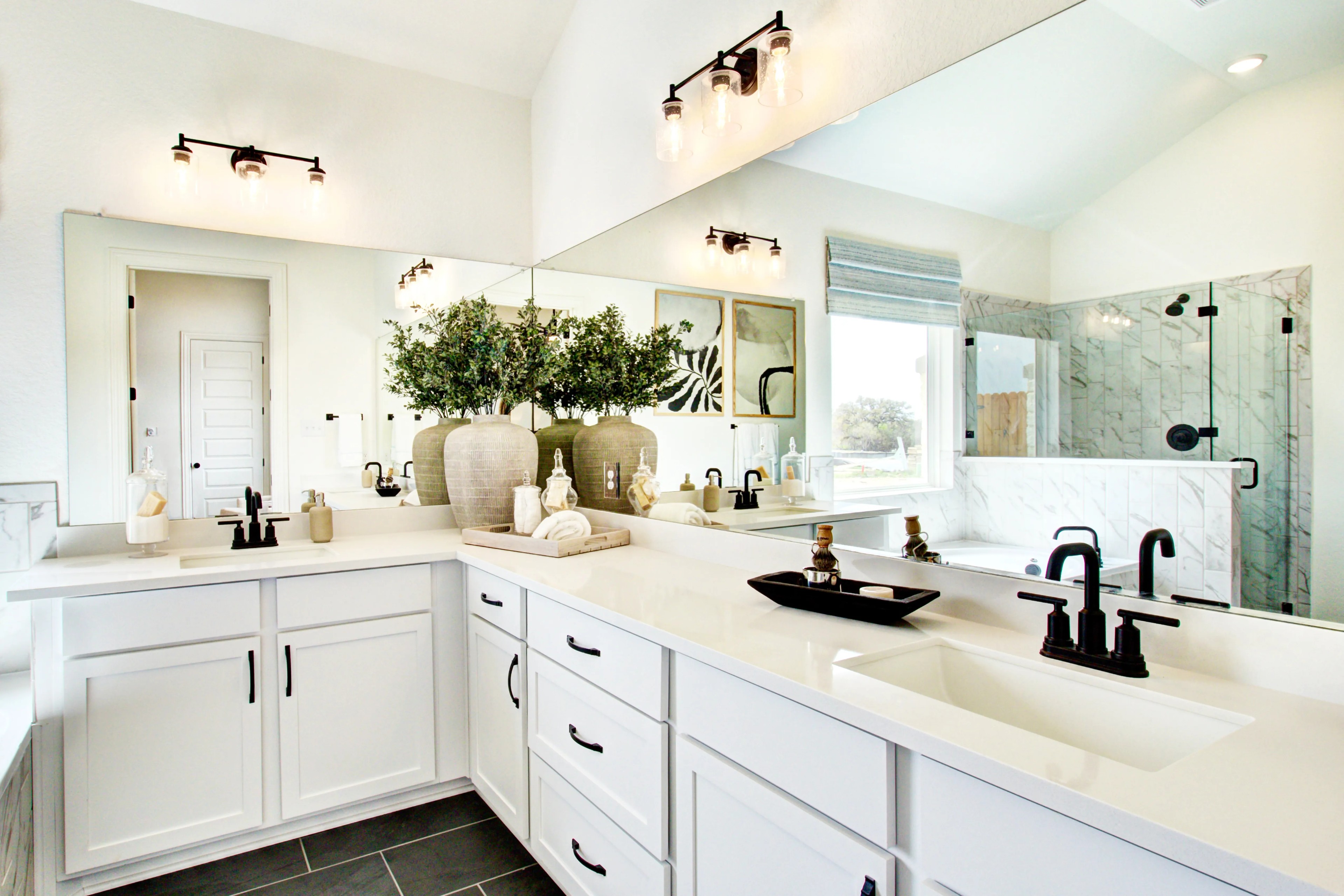 Elegant Bathroom with Double Vanity in Veranda Community Luxury bathroom with double vanity, black fixtures, marble shower, large mirror in Veranda community.