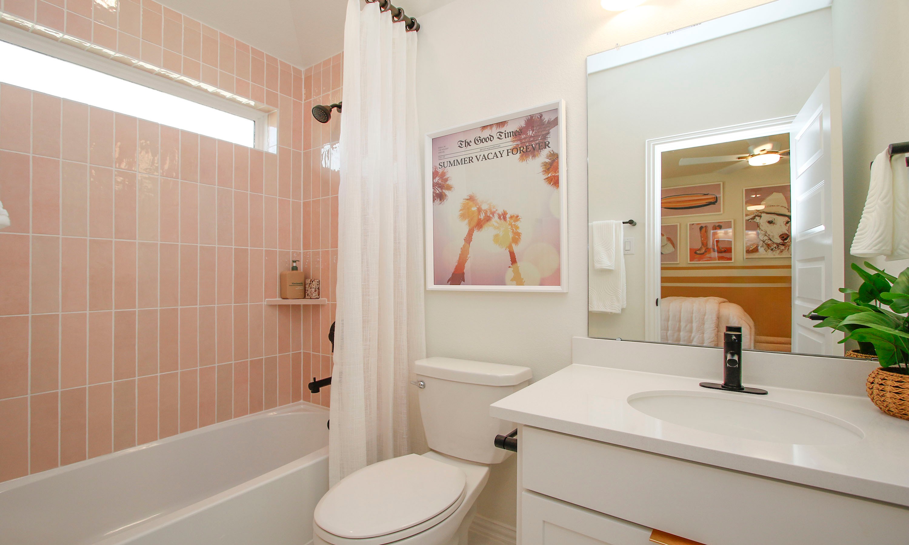 Chic Bathroom with Pink Tiles in The Woodlands Hills Elegant bathroom in The Woodlands Hills, pink tiles, sleek vanity, artwork, modern fixtures, natural light.