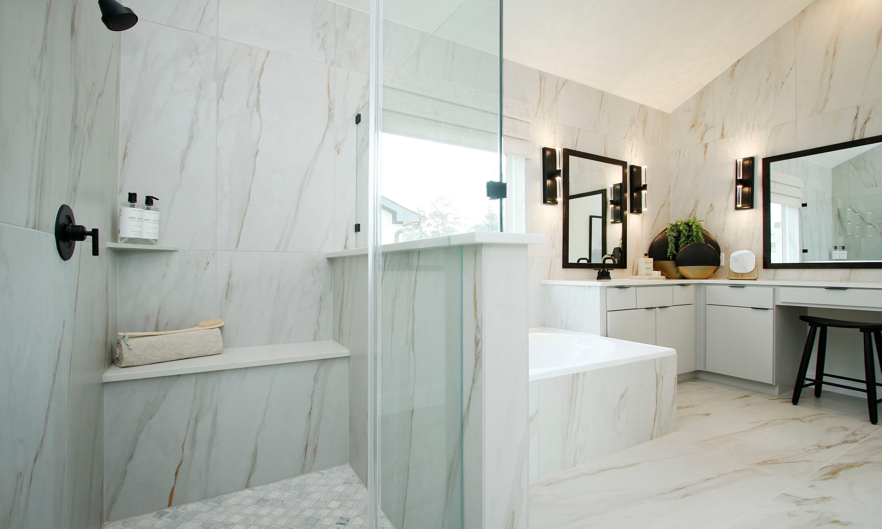 Elegant Marble Bathroom with Glass Shower in Woodlands Hills Home Luxurious bathroom with white marble walls, glass shower, dual sinks, in Woodlands Hills.