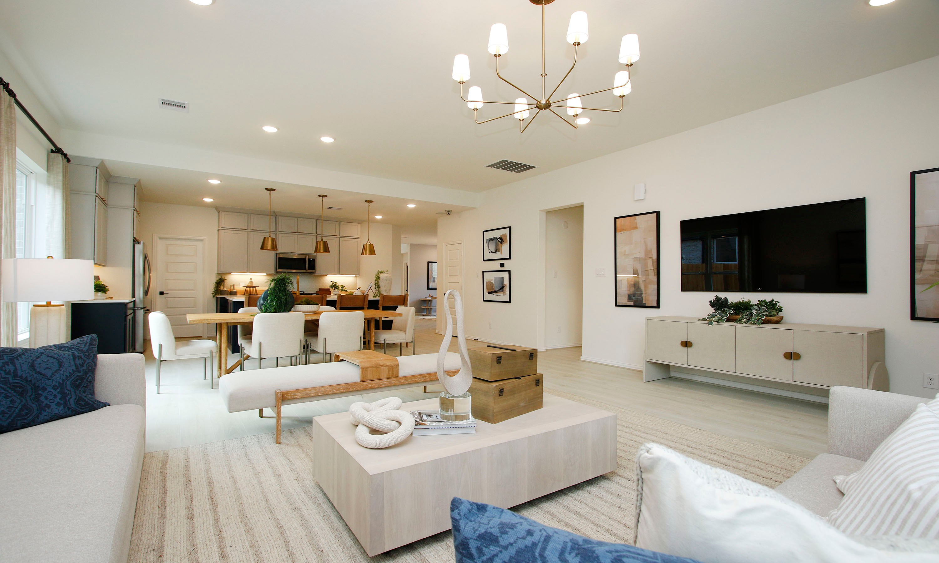 Elegant Living Room and Dining Area, The Woodlands Hills Spacious living and dining room with modern chandelier, sleek furniture, neutral palette, in The Woodlands Hills.