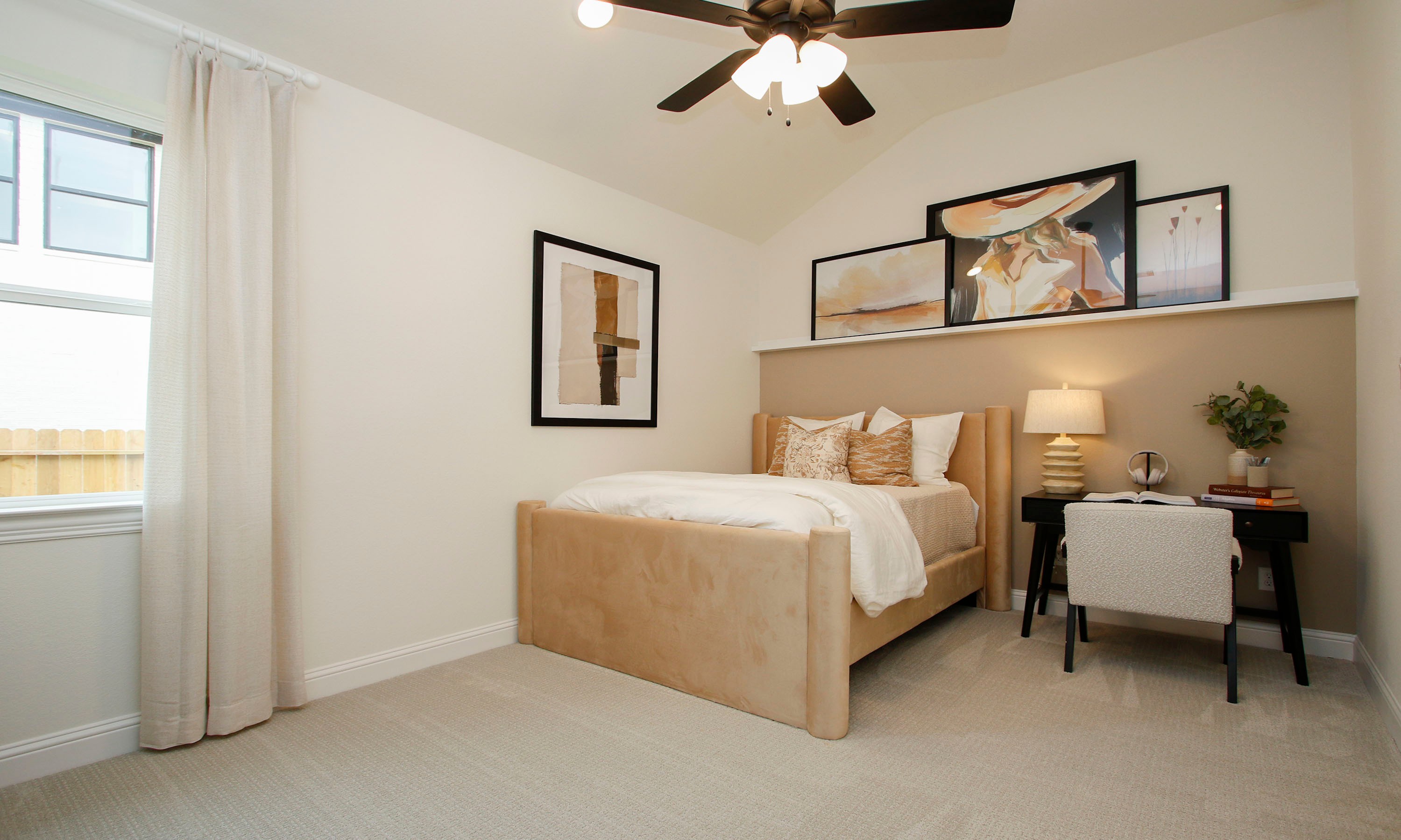 Luxurious Bedroom with Modern Art and Desk in Woodlands Hills Elegant beige bedroom with modern art, plush bedding, ceiling fan, and desk in Woodlands Hills.