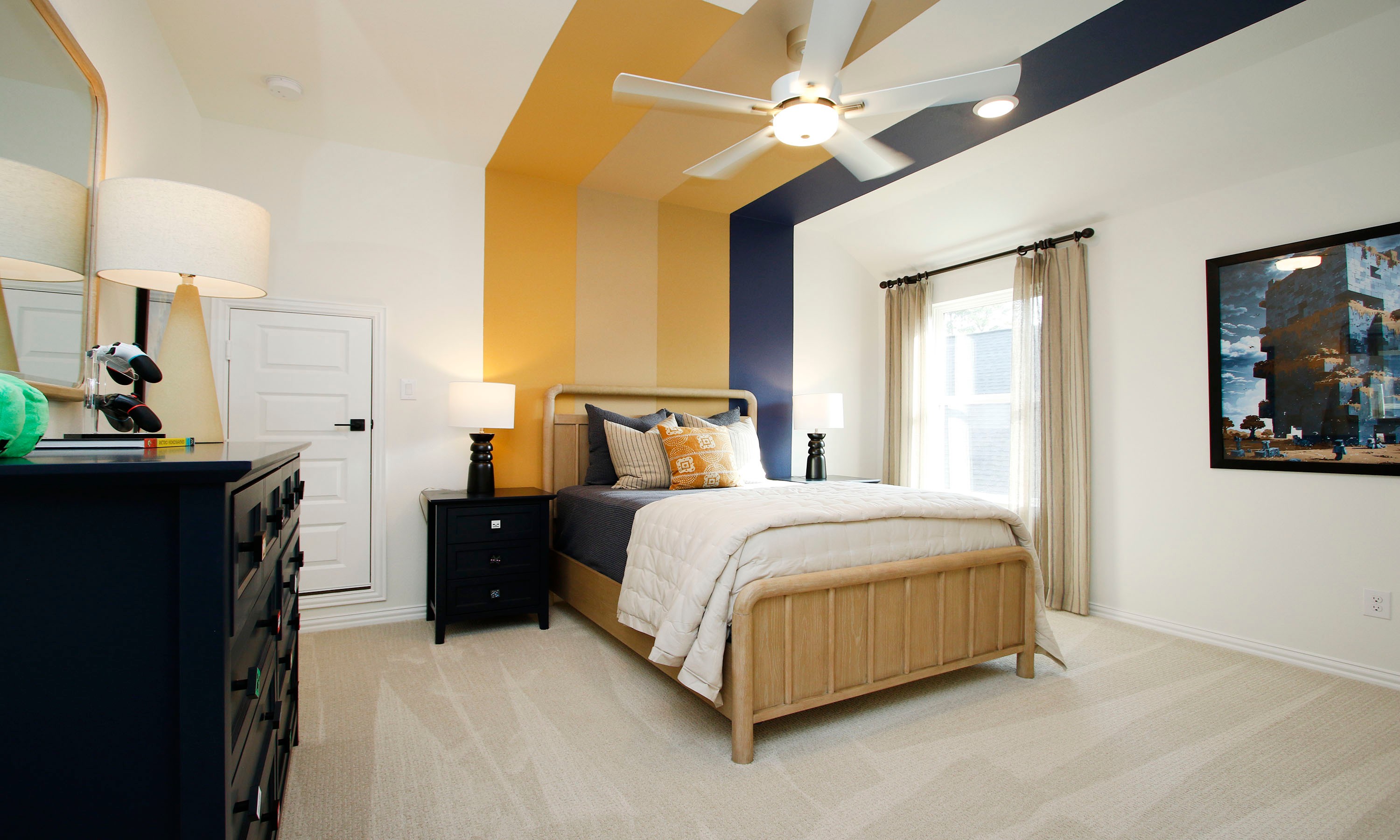 Elegant Bedroom with Striped Wall in The Woodlands Hills, Texas Bedroom with striped accent wall, cozy bedding, wooden furniture, in The Woodlands Hills community, Texas.
