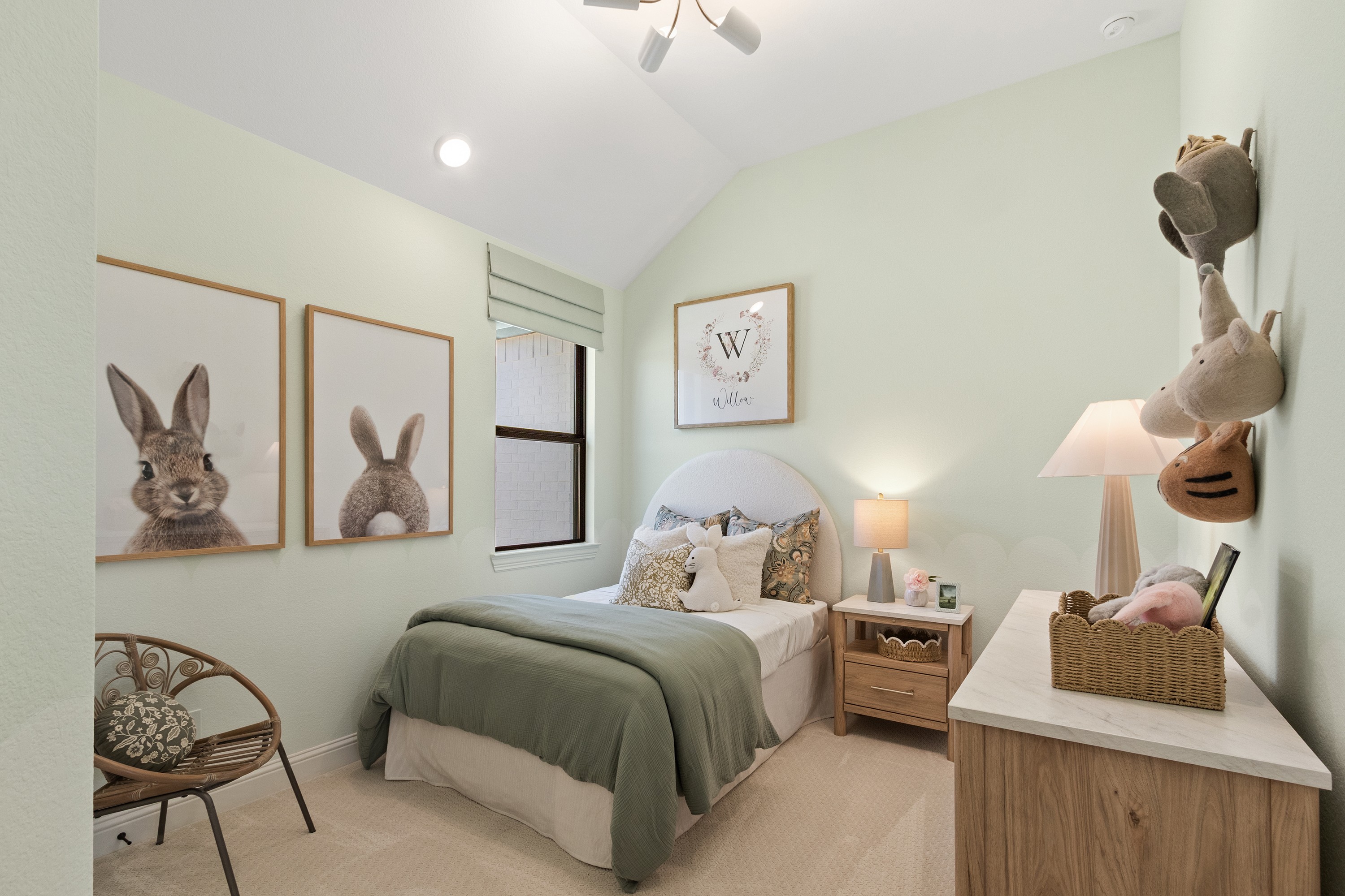 Charming Child's Bedroom Design in Oakwood Estates Child's bedroom with plush decor, pale green walls, rabbit art, and modern fixtures in Oakwood Estates.