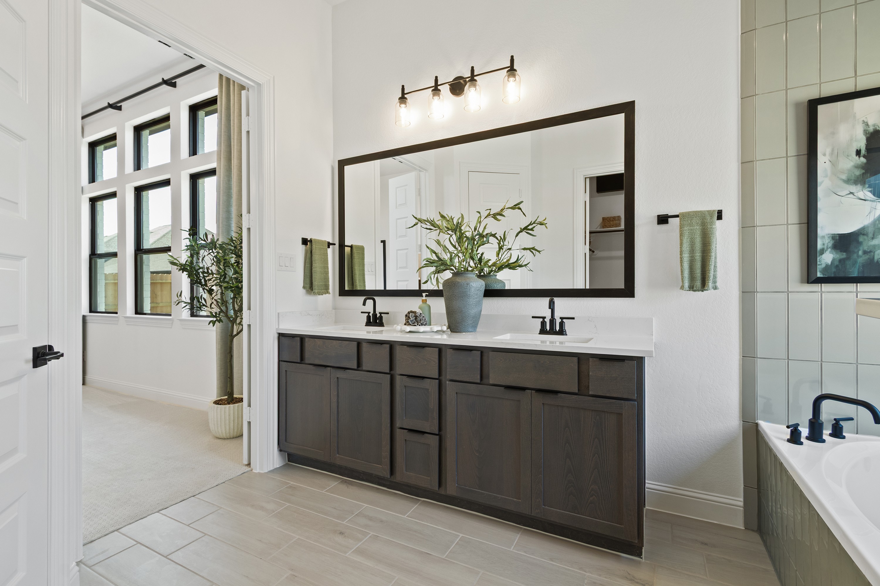 Oakwood Estates Modern Bathroom with Dual Vanity Modern bathroom with dual vanity, framed mirror, elegant lighting, in Oakwood Estates.