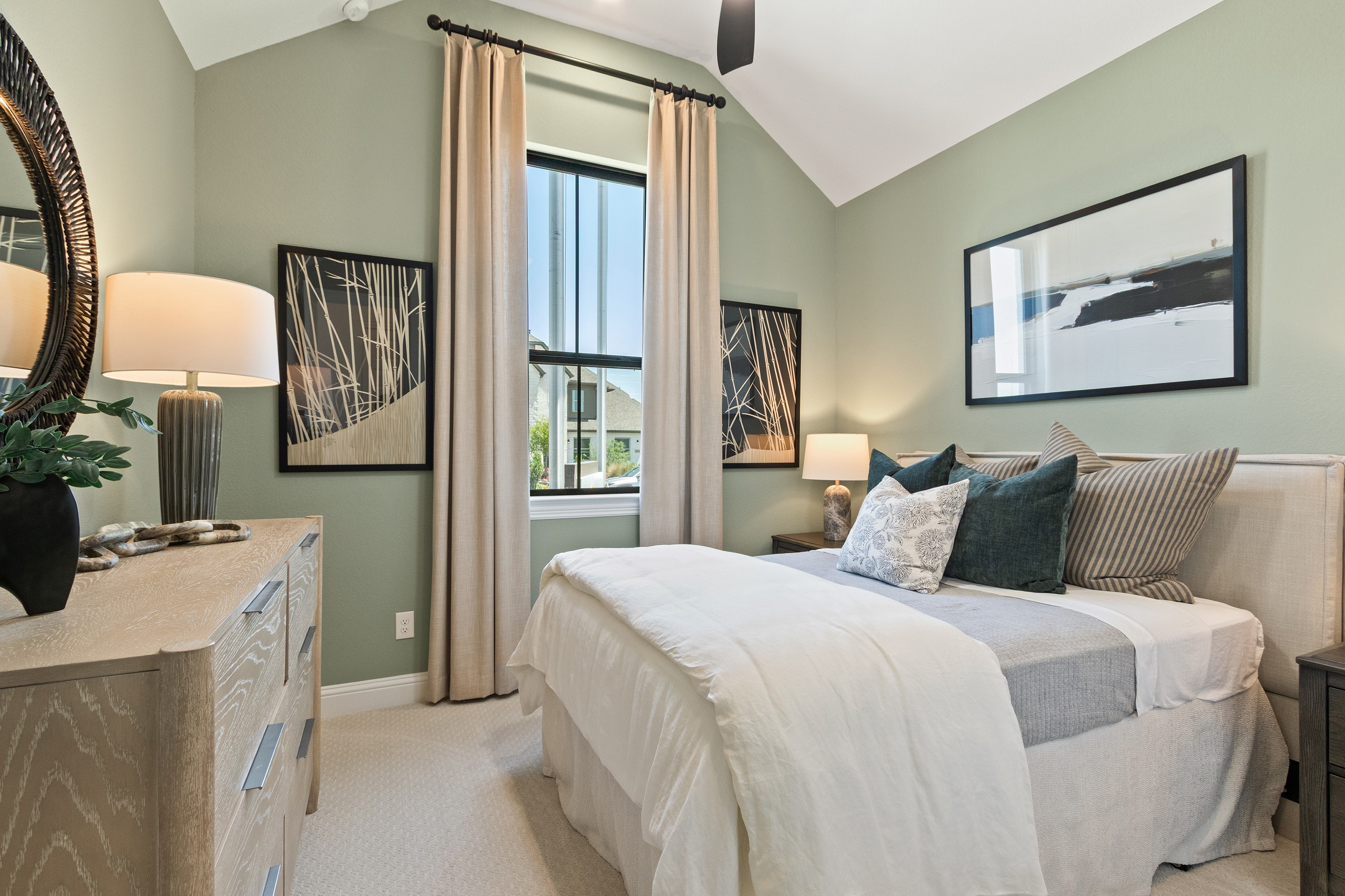 Luxurious Bedroom at Oakwood Estates with Vaulted Ceiling Spacious Oakwood Estates bedroom with vaulted ceiling, modern decor, large window, elegant lighting.