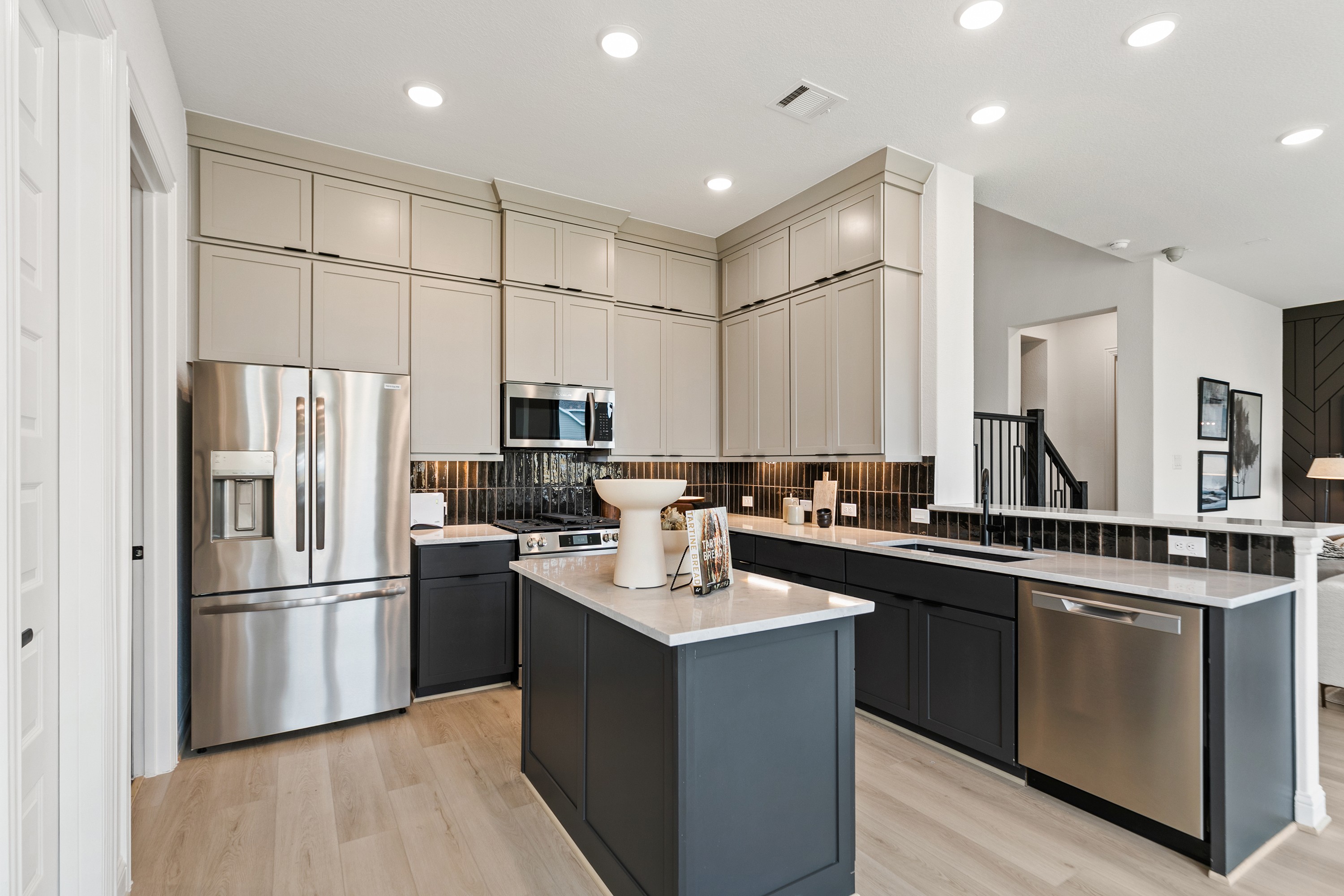 Contemporary Kitchen Design in Park at Eldridge, Houston Modern kitchen with sleek cabinetry, stainless steel appliances, and island in Park at Eldridge, Houston.