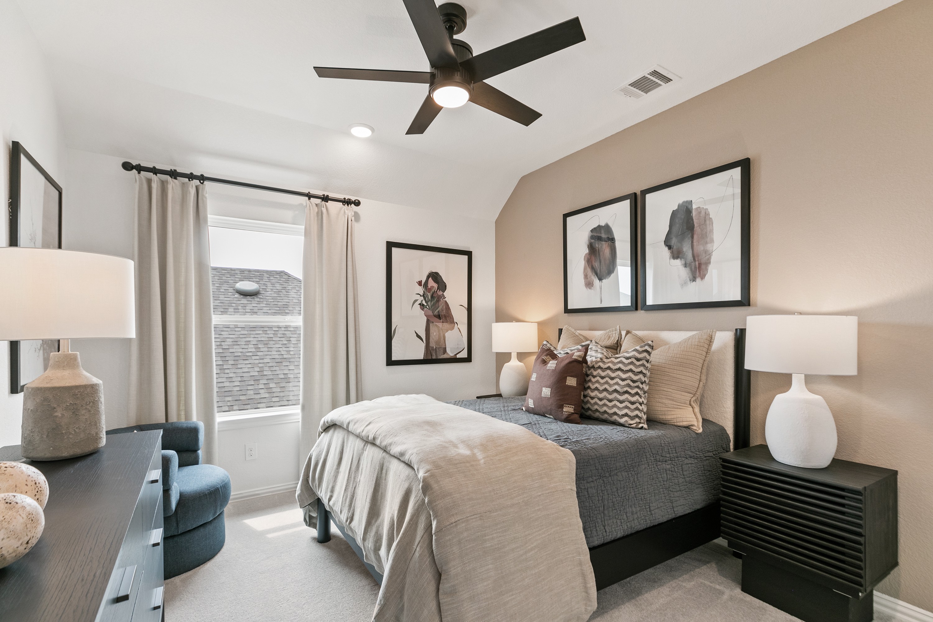 Elegant Bedroom with Abstract Art in Park at Eldridge Modern bedroom with beige accent wall, abstract art, plush bedding, at Park at Eldridge community.