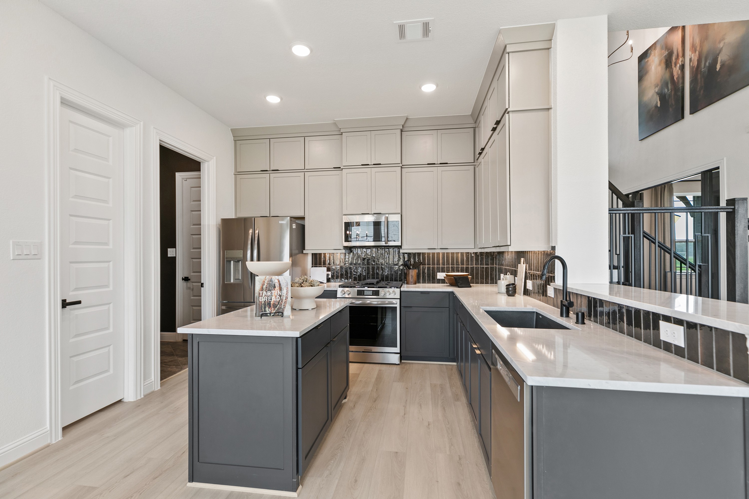Modern Kitchen with Marble Counters in Park at Eldridge, Houston Modern kitchen with sleek cabinetry, marble countertops, and stainless appliances in Park at Eldridge, Houston luxury home.