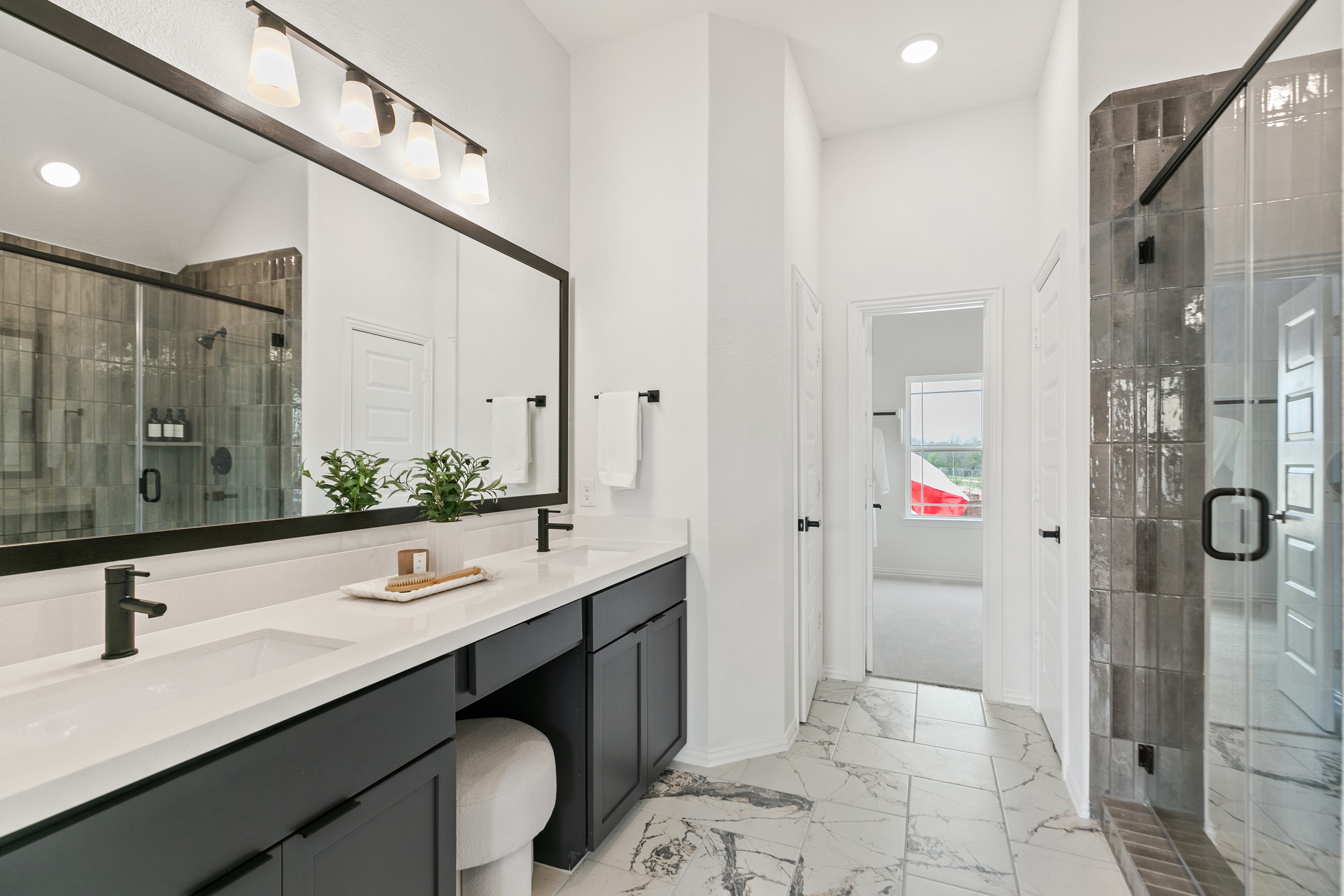 Elegant Dual Vanity Bathroom with Marble Floor at Park at Eldridge Luxurious bathroom with marble floor, dual vanity, modern fixtures, and glass shower in Park at Eldridge, Houston.
