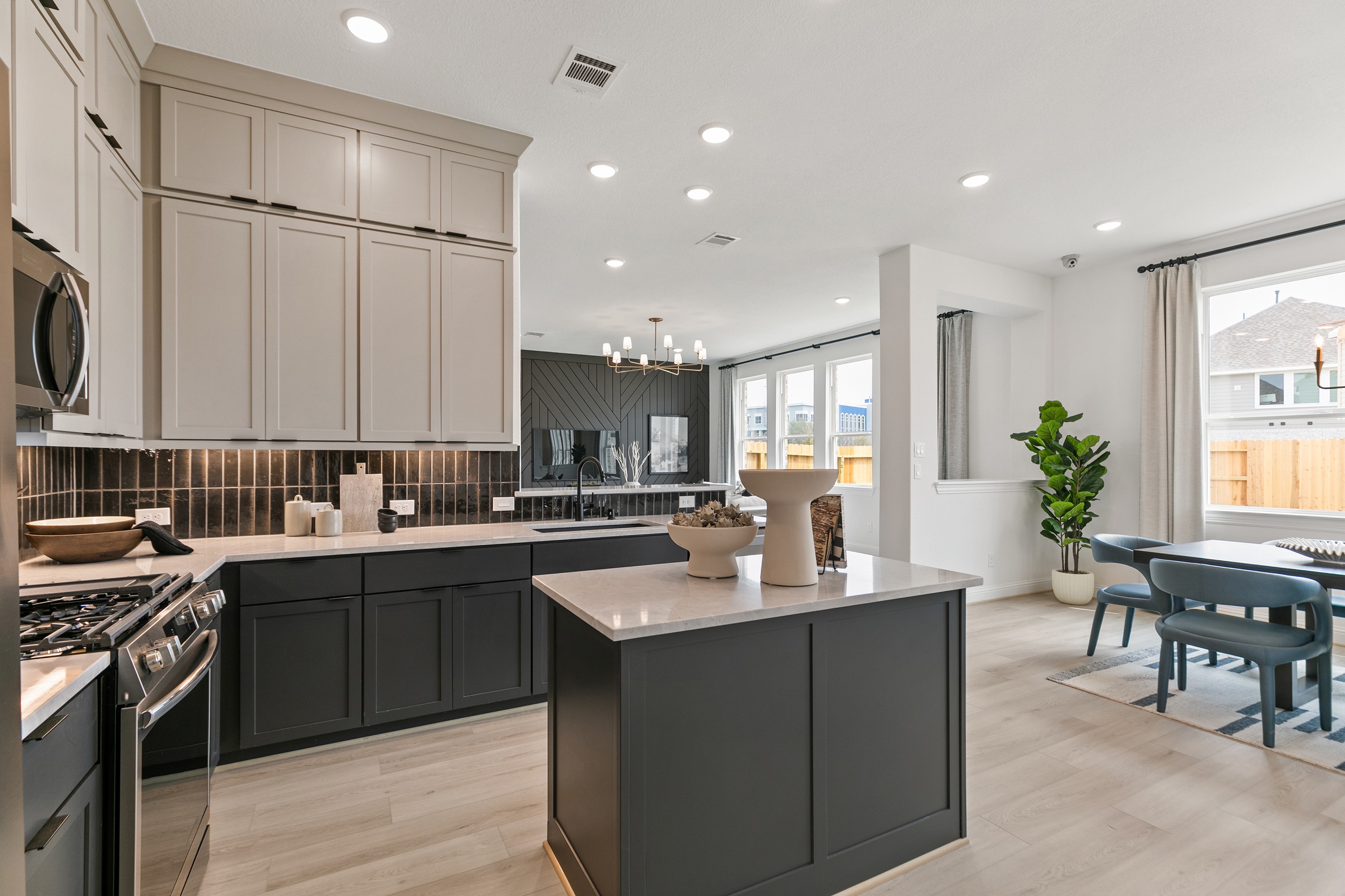 Park at Eldridge Modern Kitchen with Elegant Design Features Modern kitchen in Park at Eldridge with quartz countertops, light wood floors, elegant cabinetry, large windows.