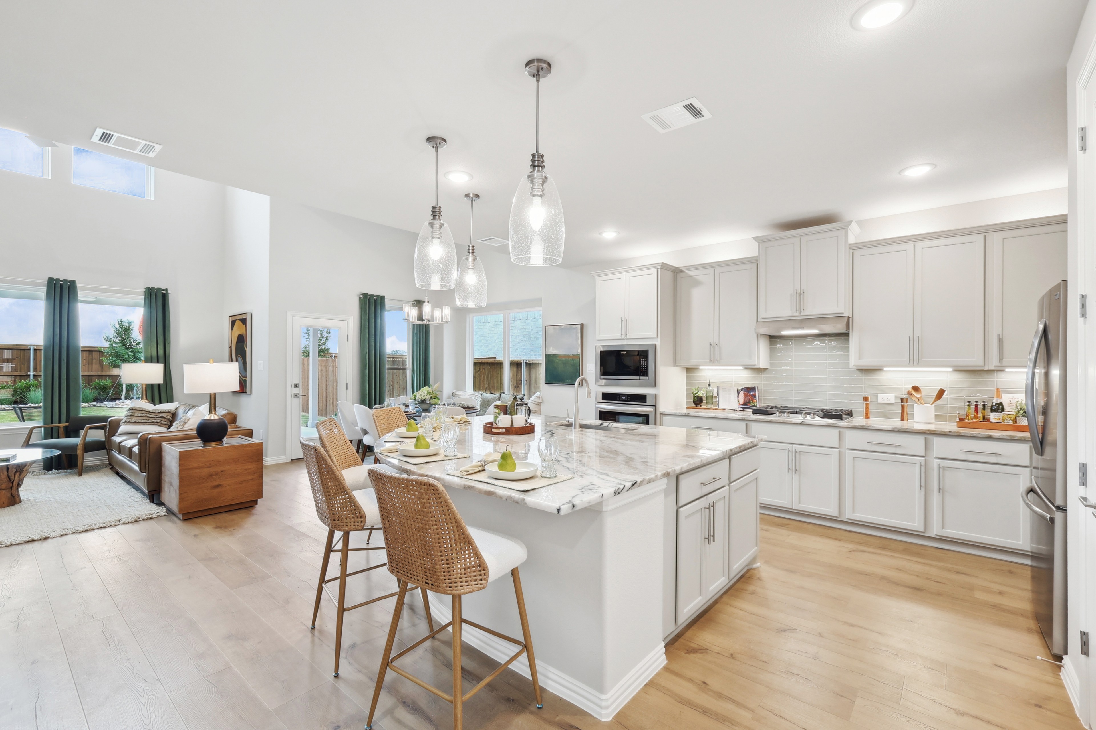 Modern Kitchen with Marble Island in Wildflower Ranch Home Spacious kitchen with marble island, modern pendant lights, and open layout in Wildflower Ranch community.