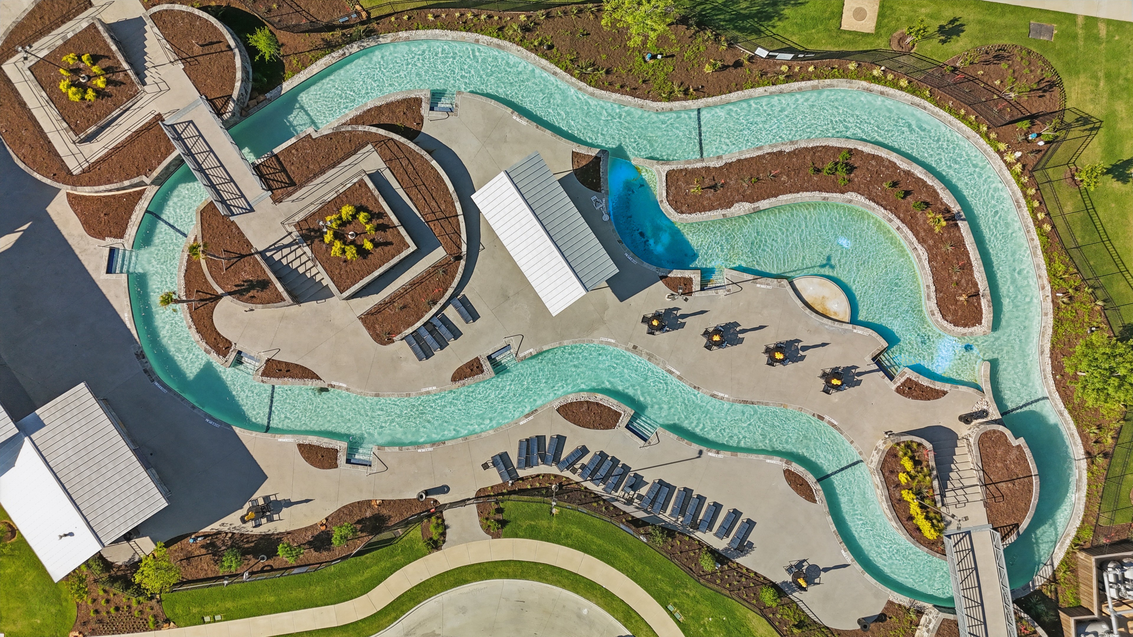 Aerial View of Lazy River in Wildflower Ranch, Texas Aerial view of a winding lazy river with modern landscaping at Wildflower Ranch, Texas.