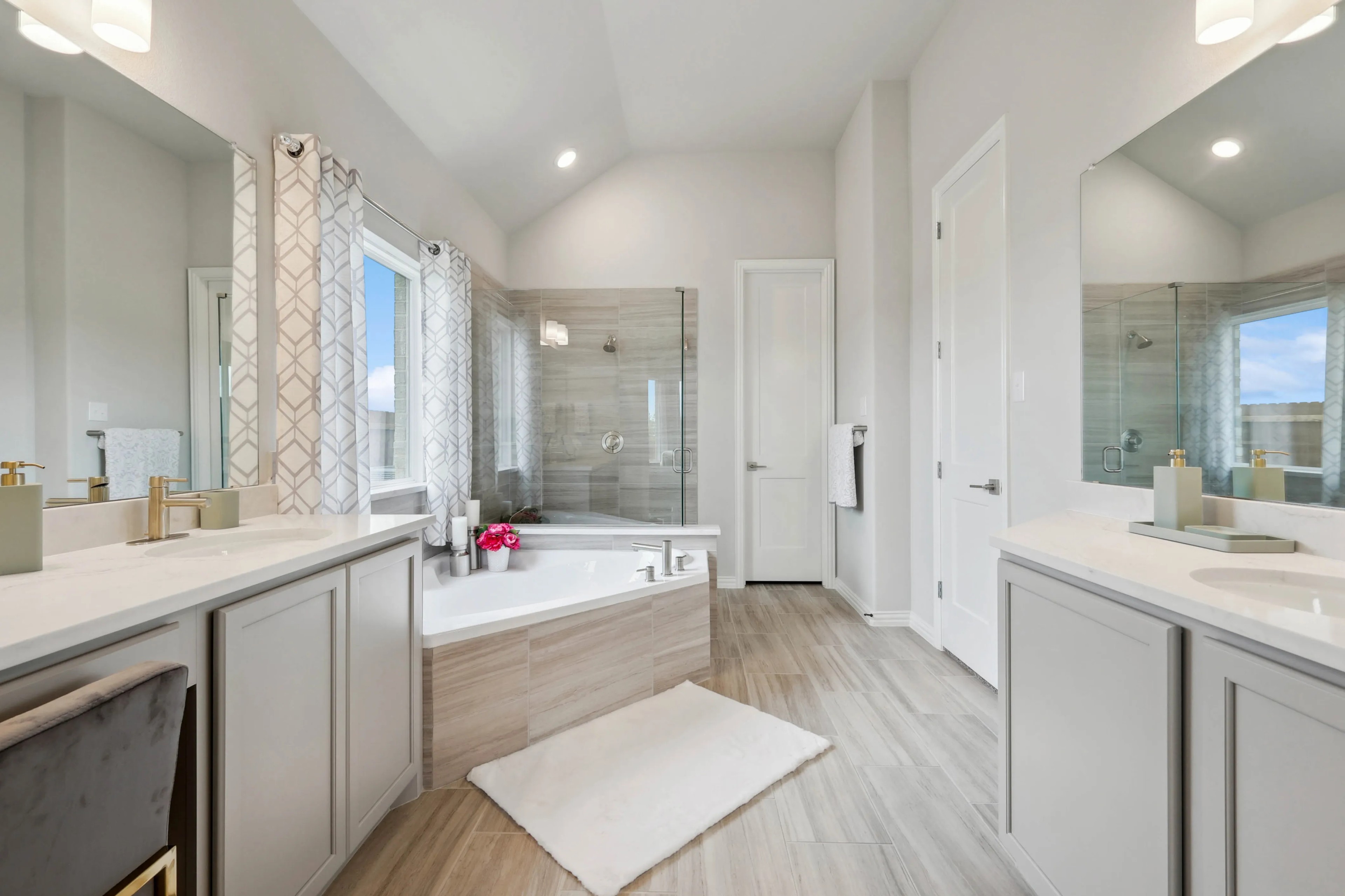 Luxurious Bathroom in Hulen Trails Featuring Modern Fixtures Luxurious bathroom with corner tub, glass shower, and modern fixtures in Hulen Trails. Neutral tones, ample natural light.