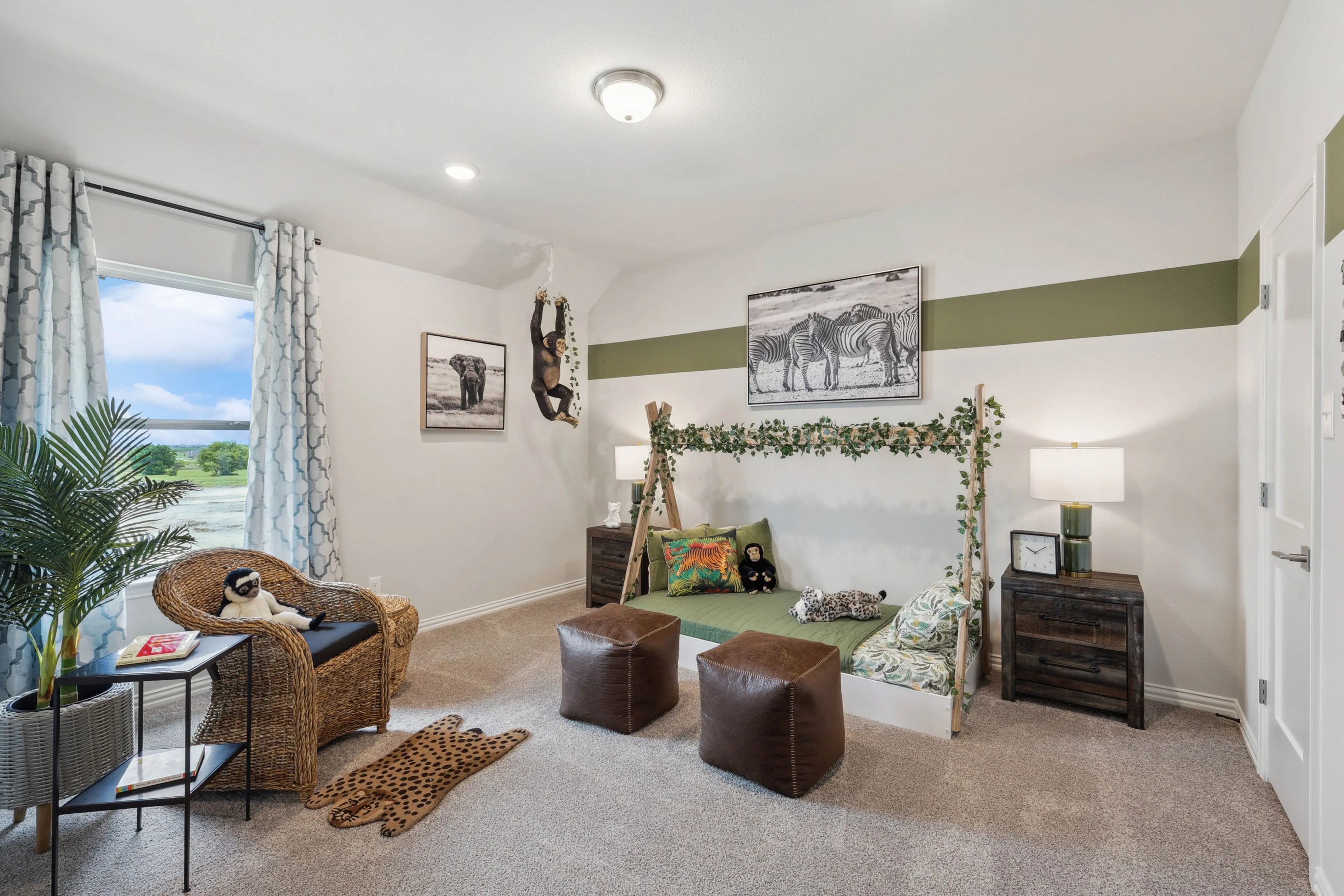 Safari-Themed Kids Room in Hulen Trails Home Children’s room with safari theme and nature decor, located in Hulen Trails. Features wicker chair, leafy frame.