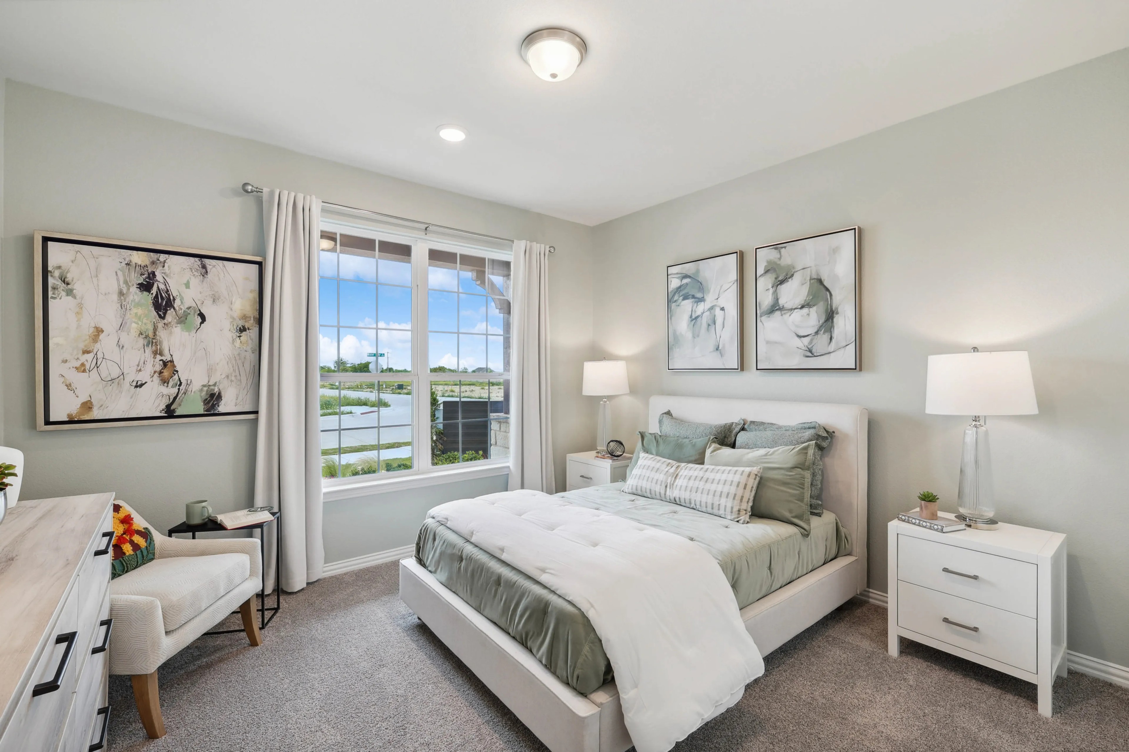 Modern Bedroom with Large Window View in Hulen Trails Elegant bedroom with large window, abstract art, and plush bedding in Hulen Trails community.