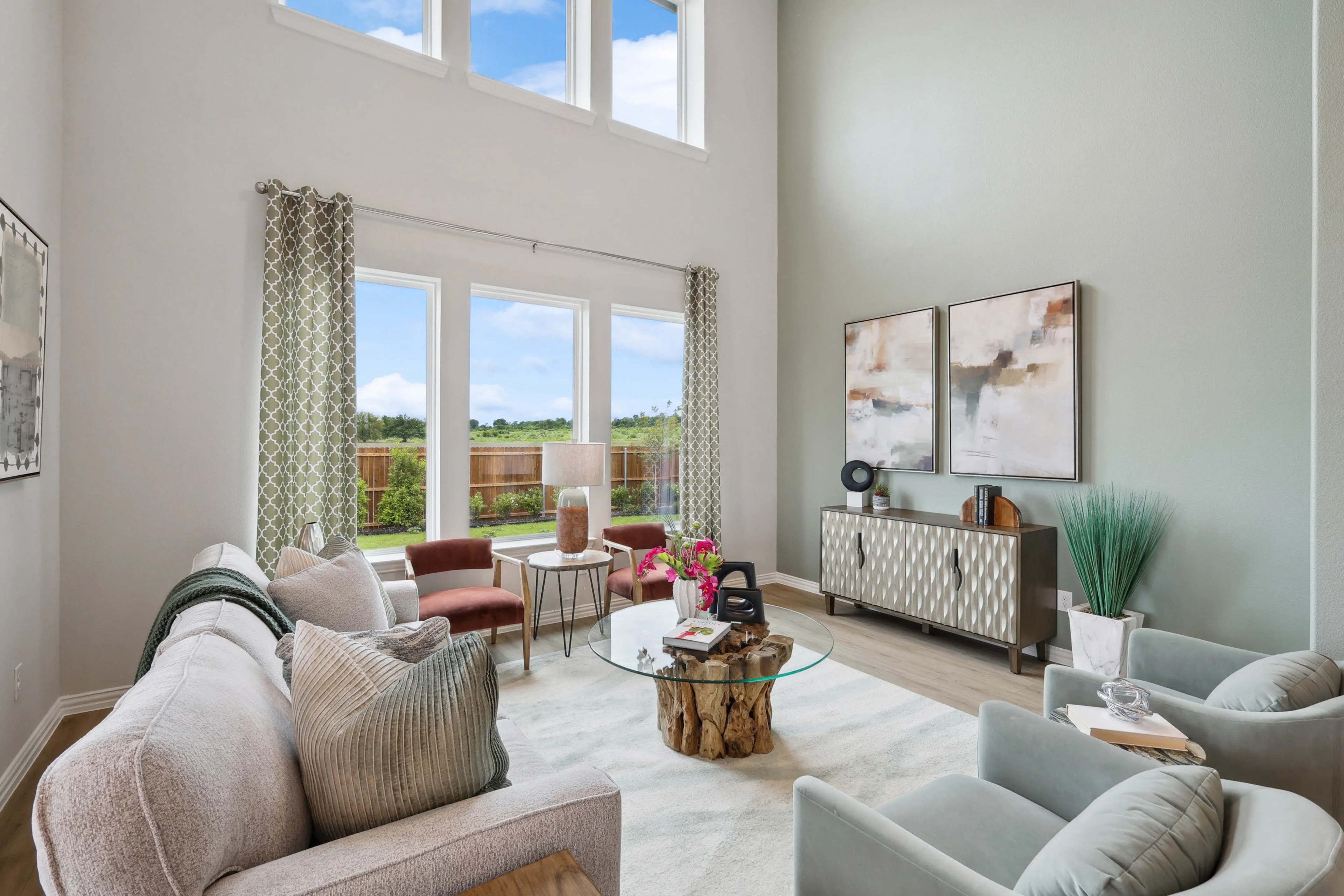 Modern Living Room with Tall Windows in Hulen Trails, Texas Spacious modern living room with tall windows, elegant decor, and neutral tones, in Hulen Trails, Texas.
