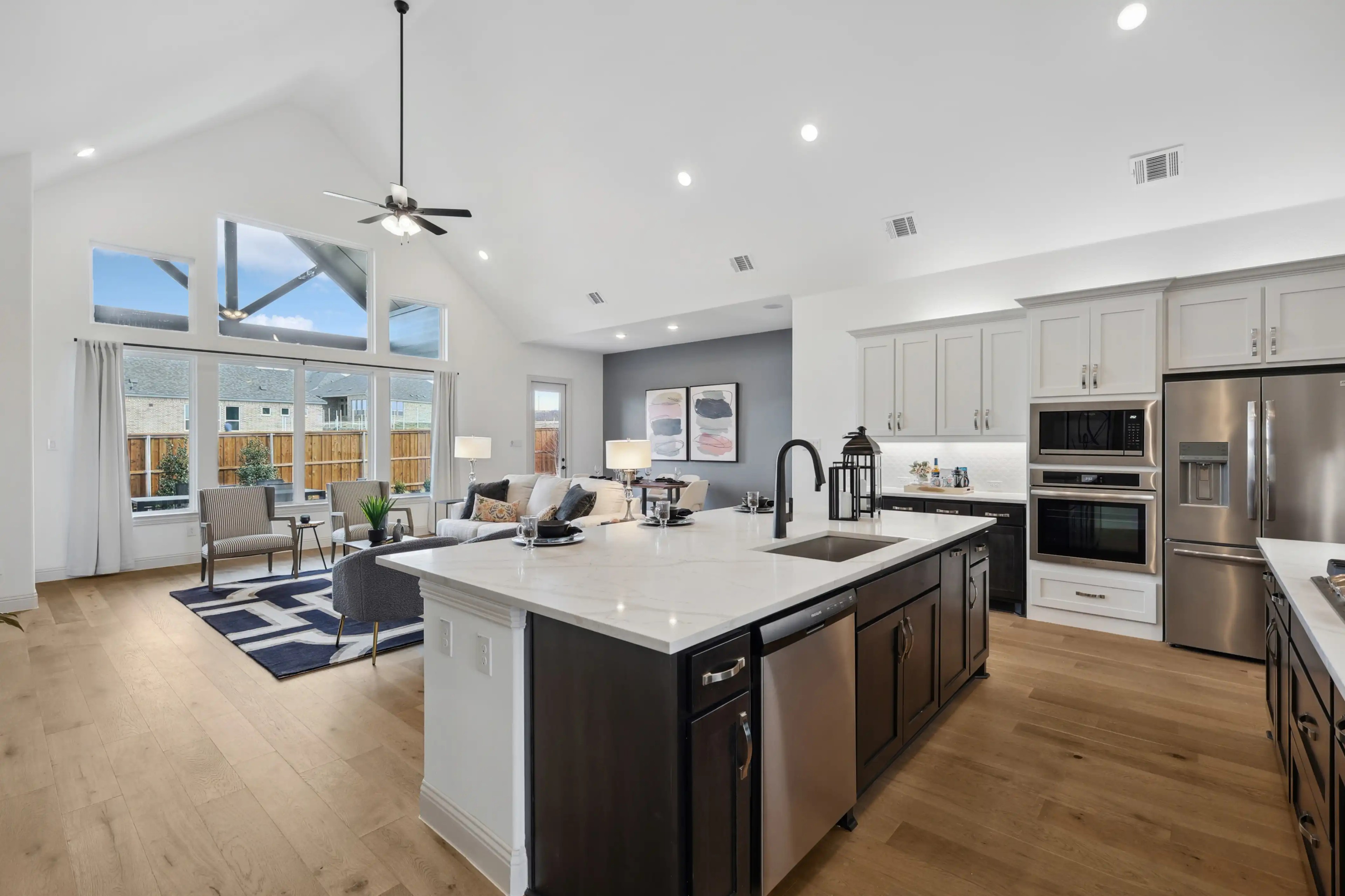 Open-Concept Kitchen-Living Area in Westside Preserve Open-concept kitchen-living area with high ceilings, island, and natural light in Westside Preserve.