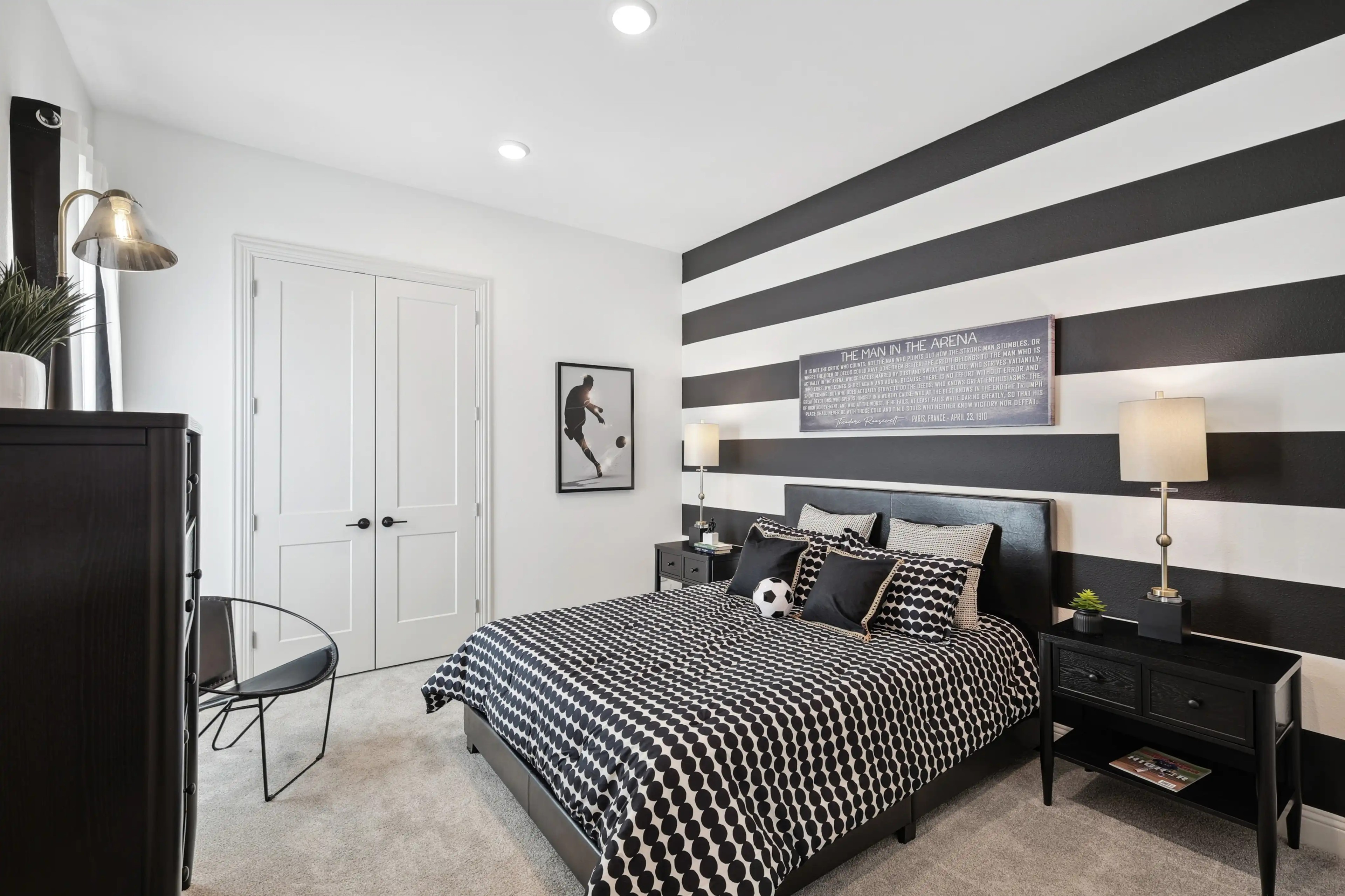 Westside Preserve Modern Bedroom with Striped Wall Design Bedroom with bold black and white striped wall, modern decor, and double doors in Westside Preserve home.