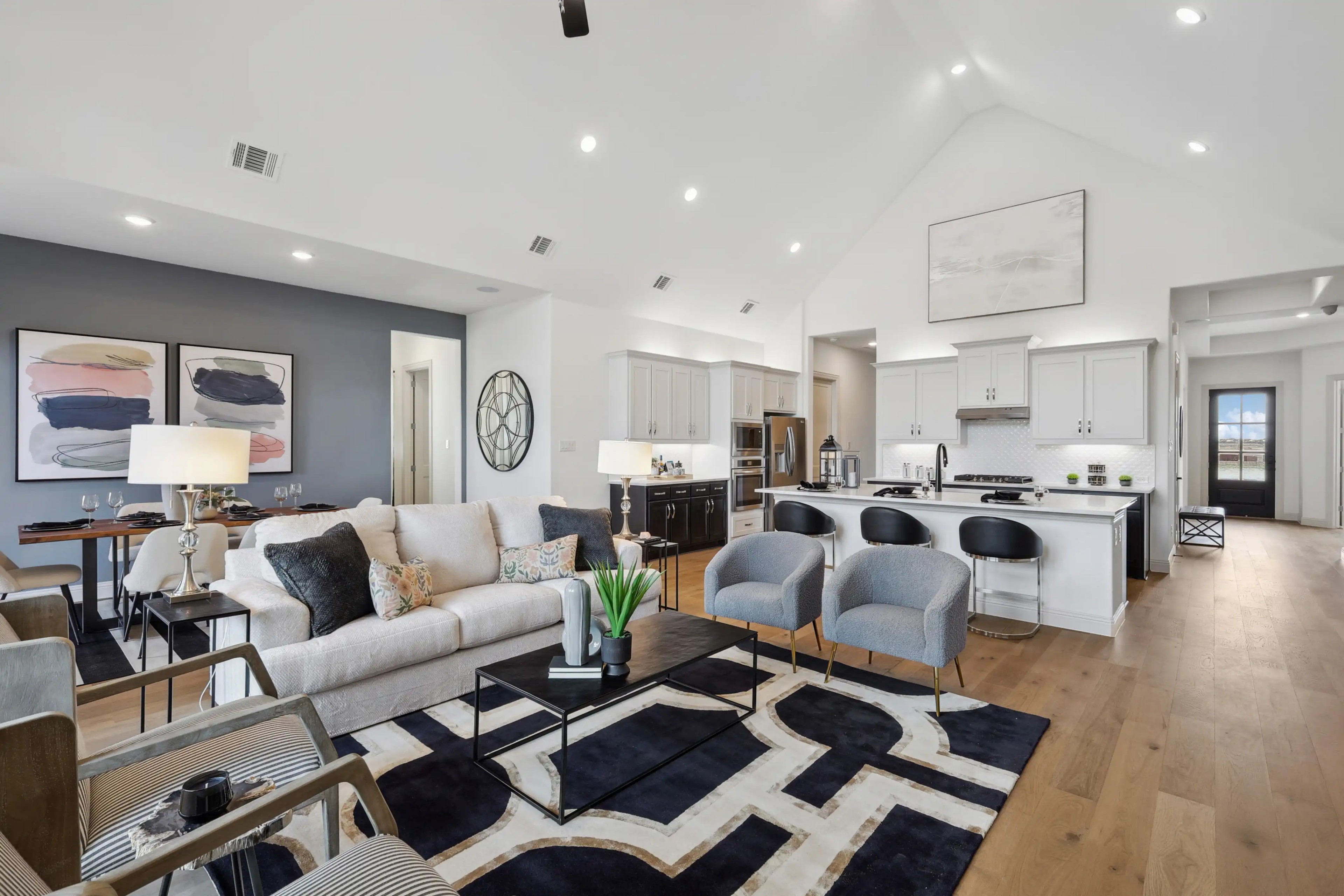 Open-Concept Living Room and Kitchen in Westside Preserve Modern open-concept living room and kitchen with high ceilings, elegant furnishings, in Westside Preserve.