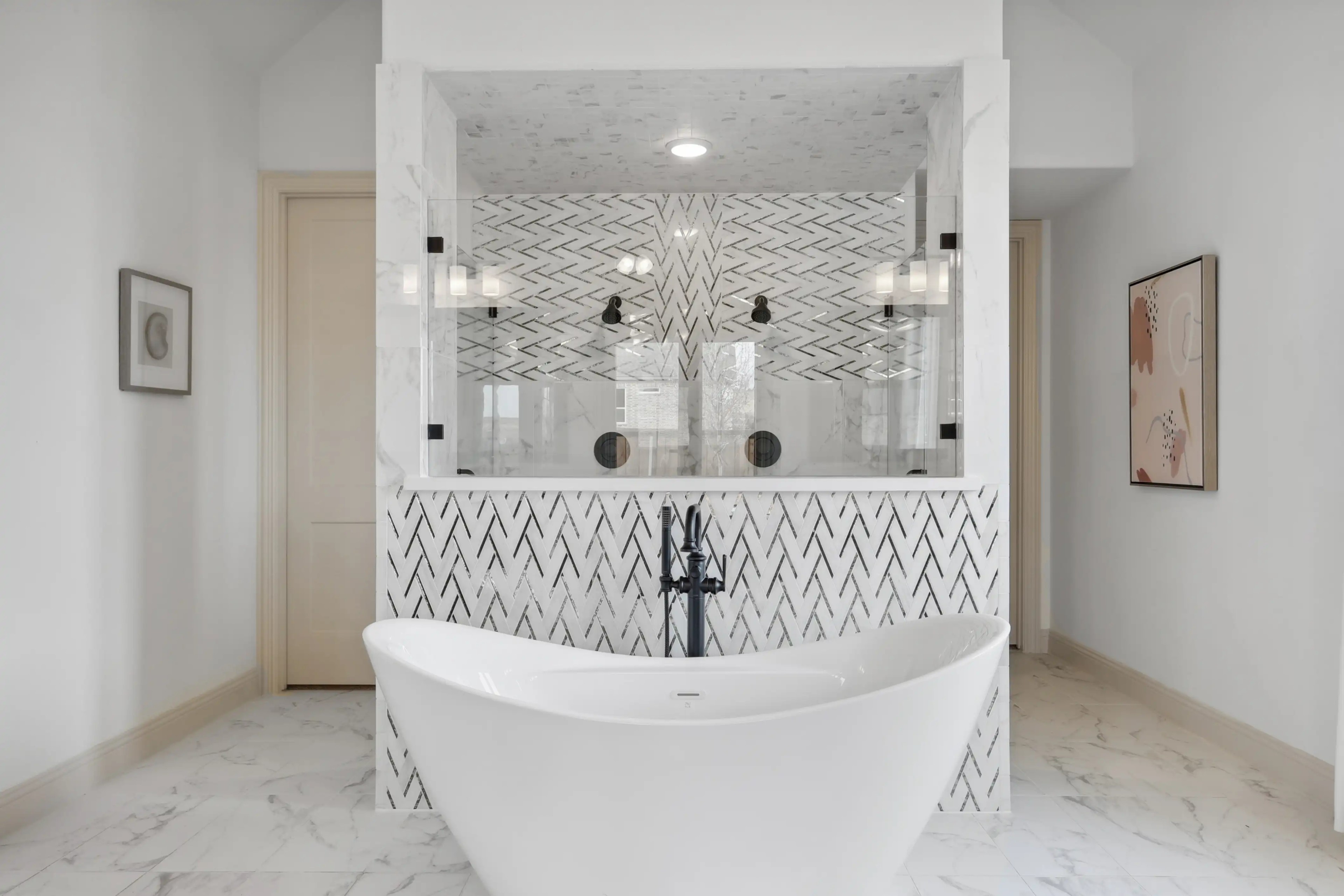 Exquisite Bathroom with Freestanding Tub, Westside Preserve Luxurious bathroom in Westside Preserve, features freestanding tub, herringbone tile, and marble details.