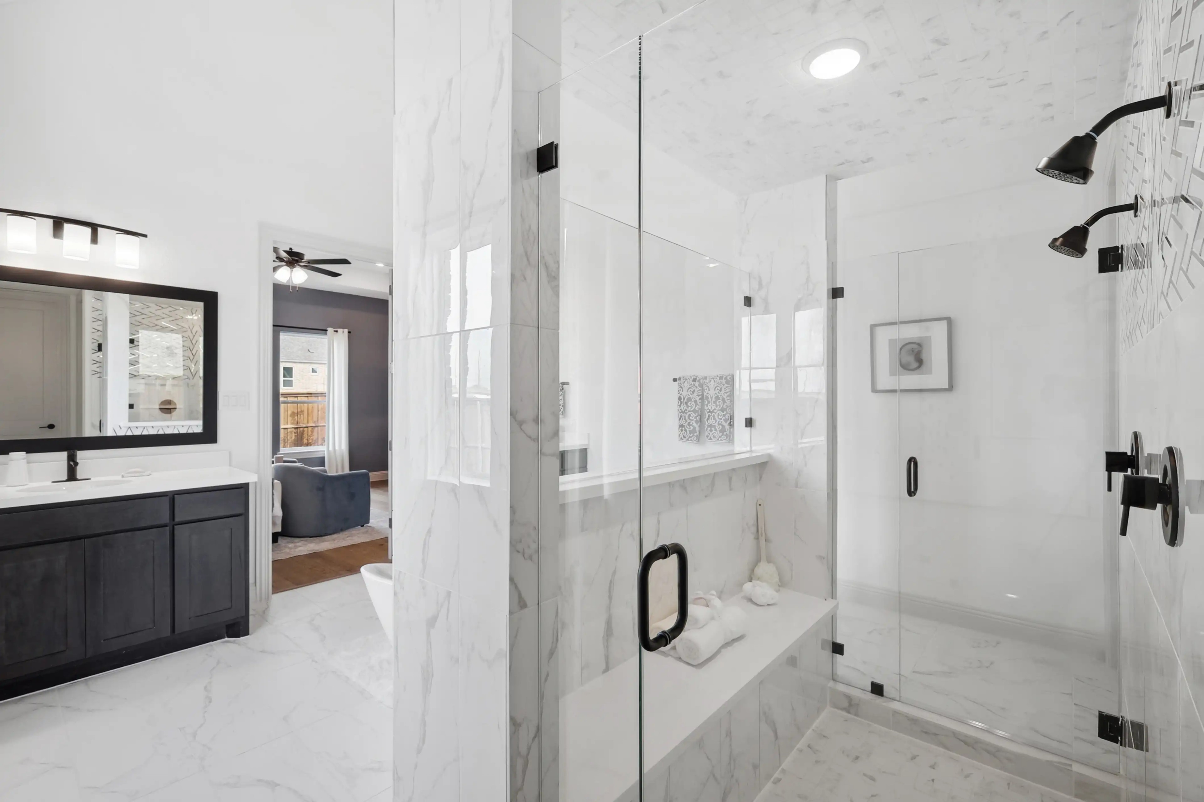 Luxurious Marble Bathroom Design in Westside Preserve Residence Luxurious marble bathroom with glass shower, double vanity, dark wood cabinets in Westside Preserve.