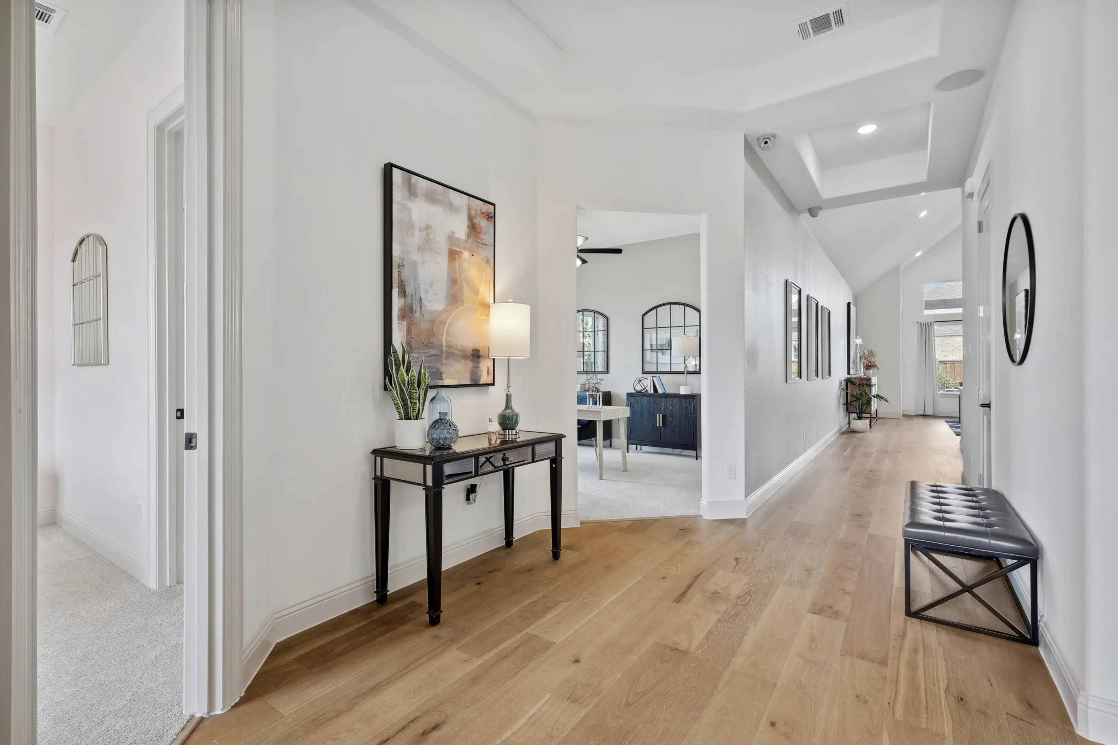 Elegant Hallway in Westside Preserve Luxury Home Elegant hallway in luxury Westside Preserve home with hardwood floors, recessed lighting, and modern decor.