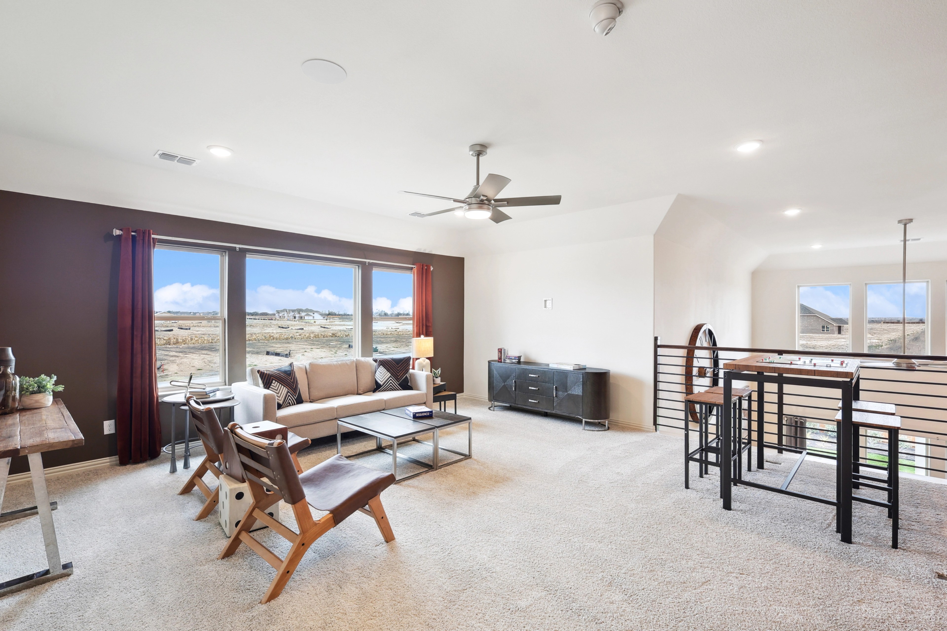 Modern Living Room in The Oaks Community Modern living room with large windows, stylish furniture, and open layout in The Oaks community.