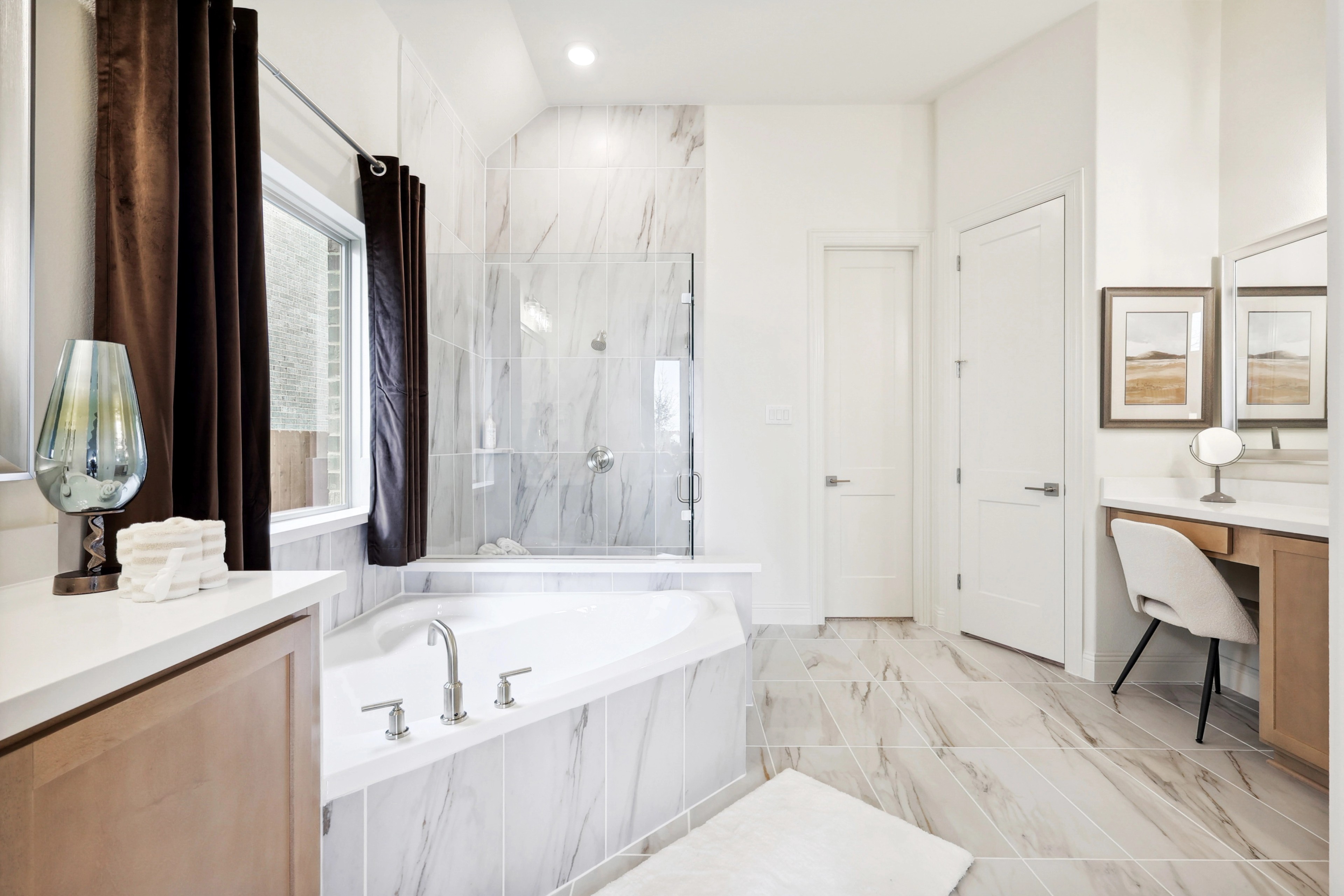 Elegant Marble Bathroom Design at The Oaks Community Luxurious bathroom with marble tiles, glass shower, soaking tub, and vanity. The Oaks community.