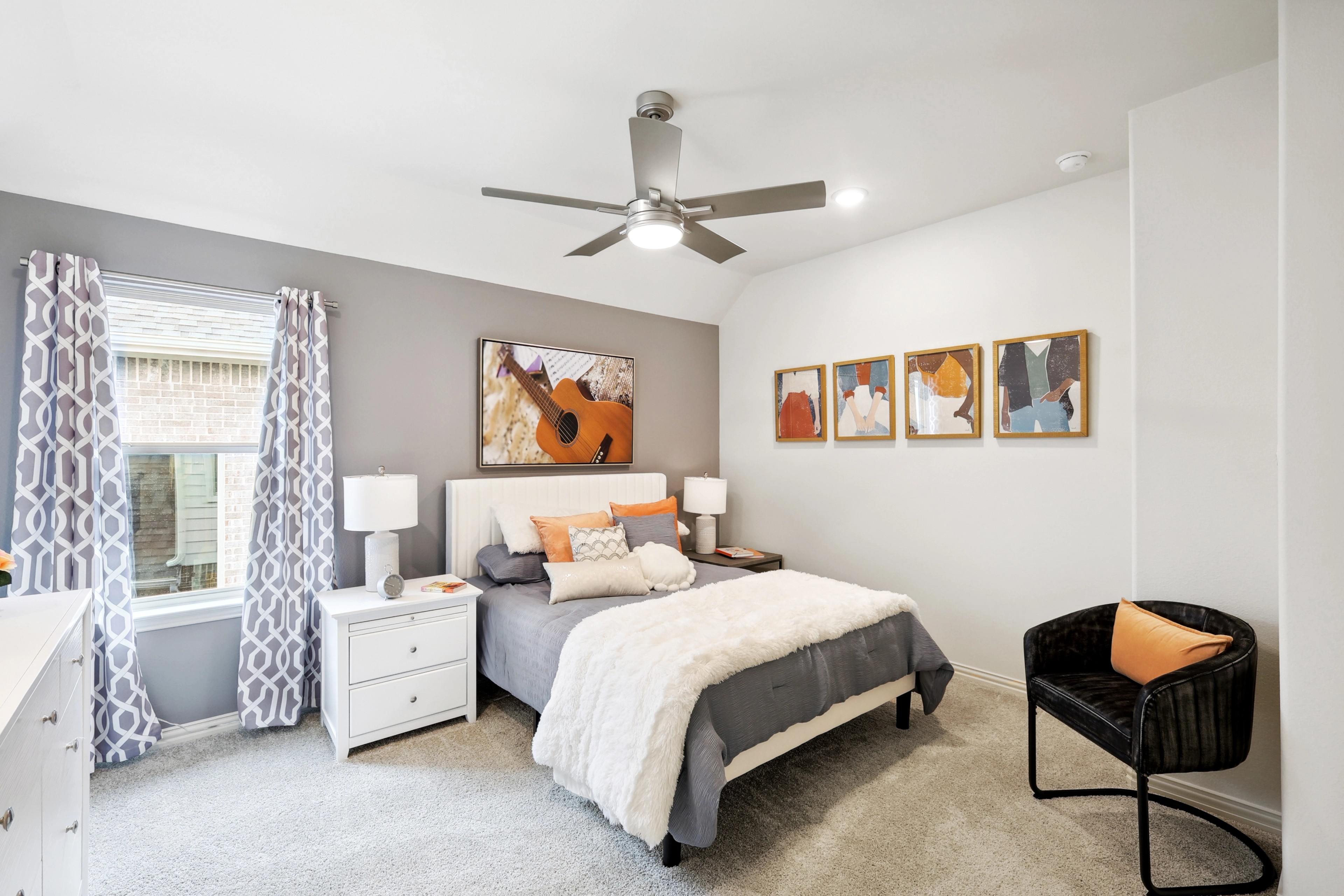 Contemporary Bedroom Design at The Oaks with Elegant Decor Modern bedroom with elegant decor, featuring a stylish ceiling fan, plush bedding, and vibrant artwork, The Oaks.