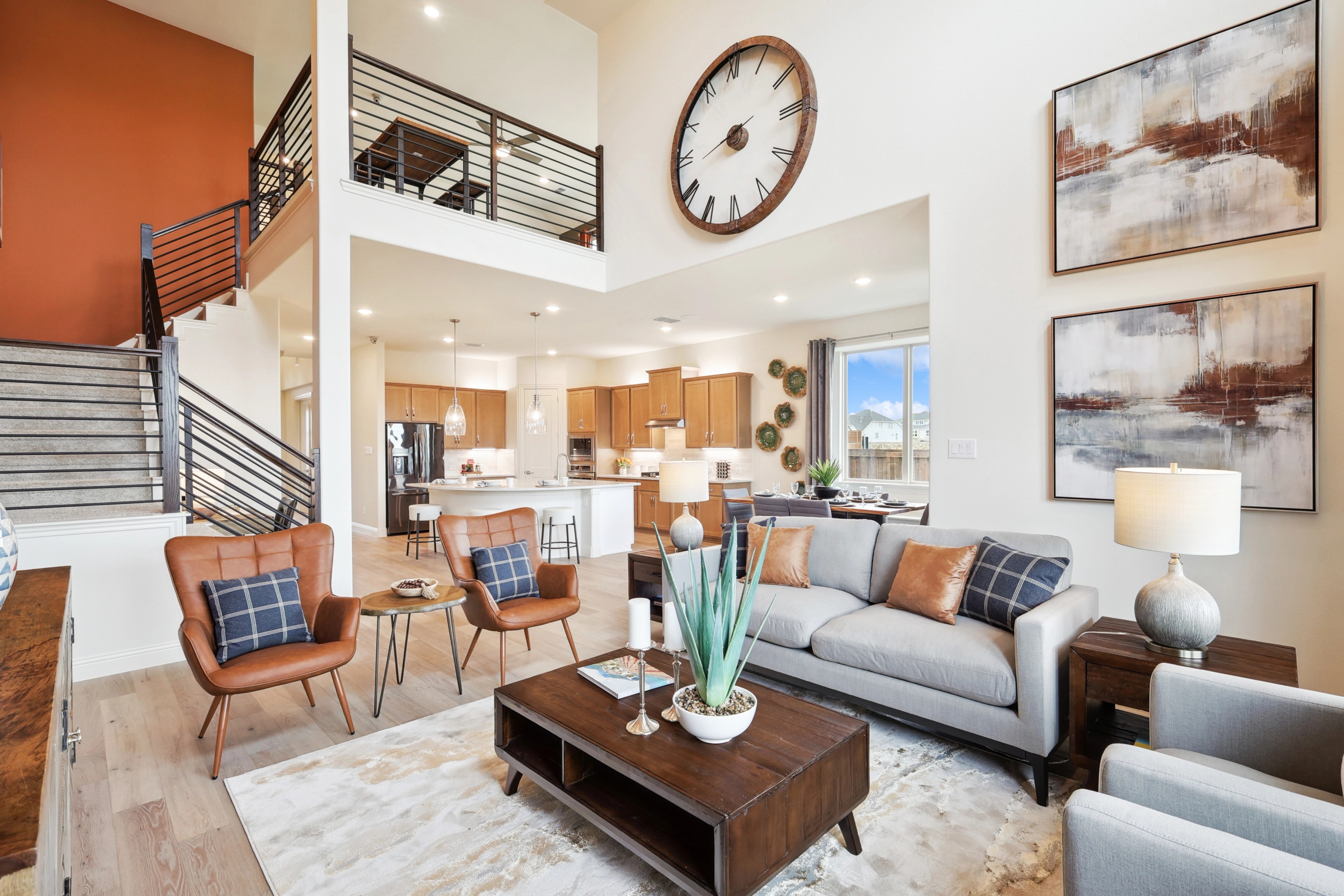 Luxurious Open Floor Plan Living Room at The Oaks Community Luxury modern living room with open floor plan, elegant decor, large clock, and balcony in The Oaks.