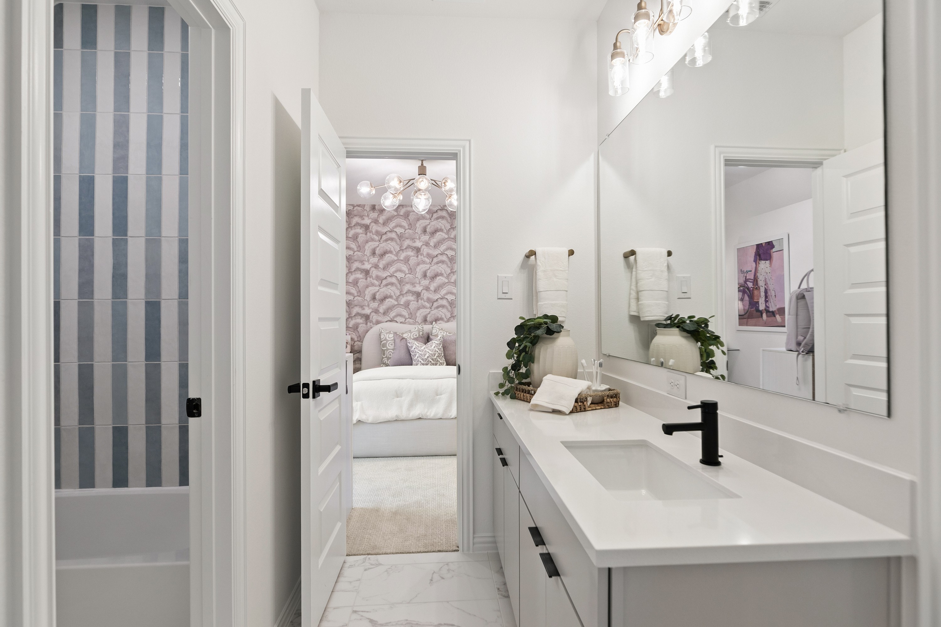 Modern Bathroom with Elegant Fixtures in Katy Lakes Home Modern bathroom with sleek white vanity, elegant fittings, and vibrant striped tiles in Katy Lakes home.