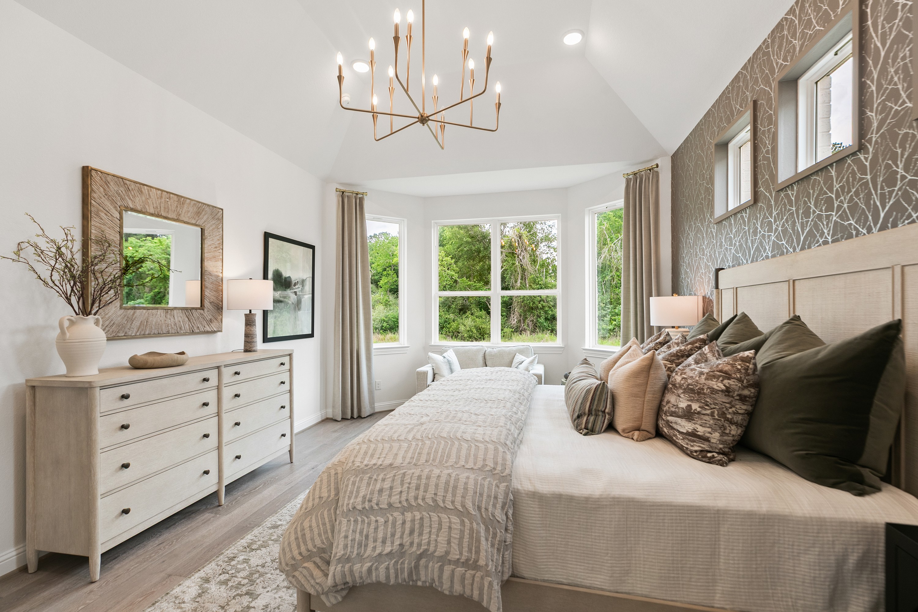 Katy Lakes Luxury Bedroom with Chandelier and Scenic Views Luxurious bedroom in Katy Lakes with chandelier, large windows, nature view, elegant decor, and textured wallpaper.