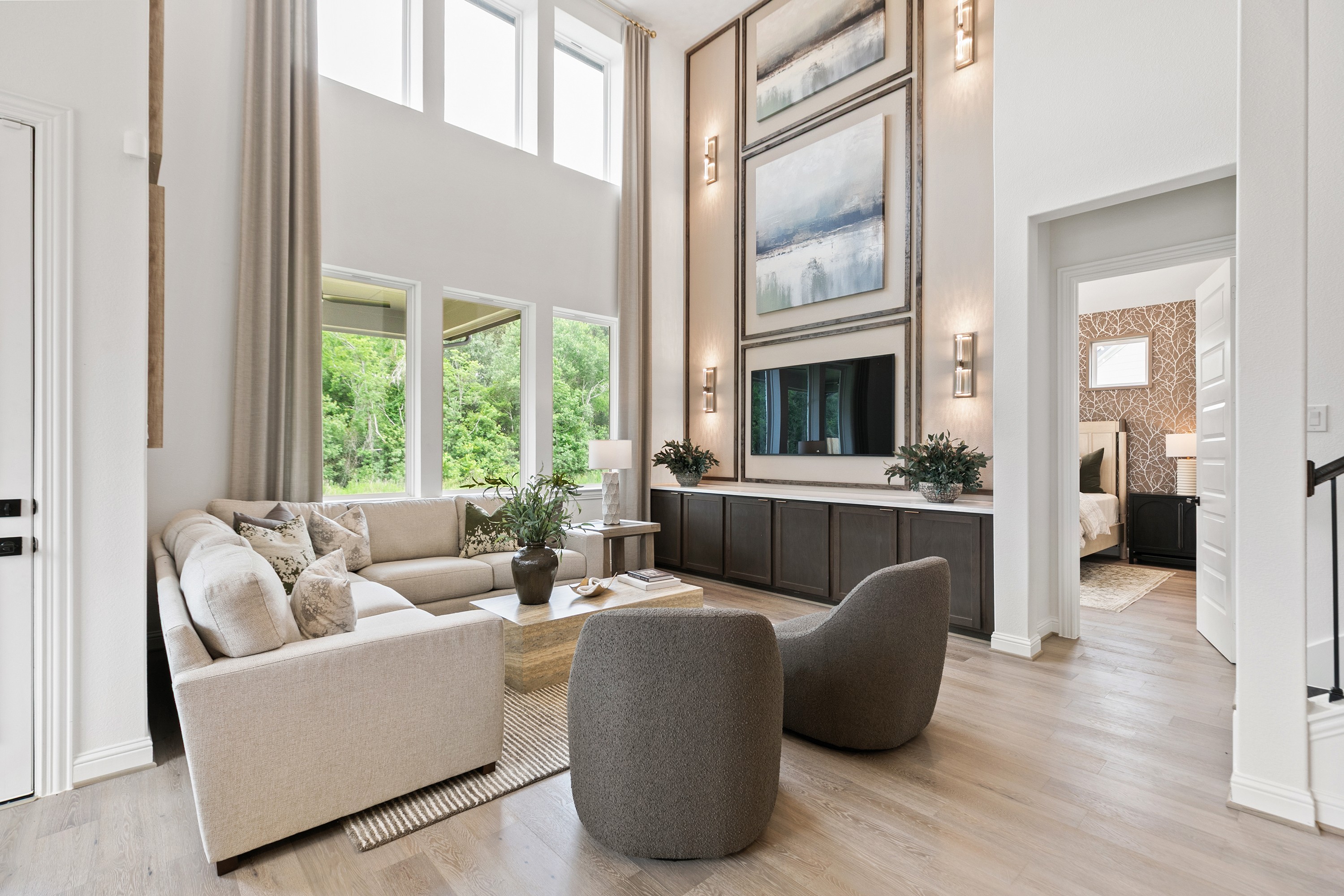 Elegant Living Room with High Ceilings in Katy Lakes Community Spacious living area with high ceilings, large windows, modern decor, neutral tones in Katy Lakes community.