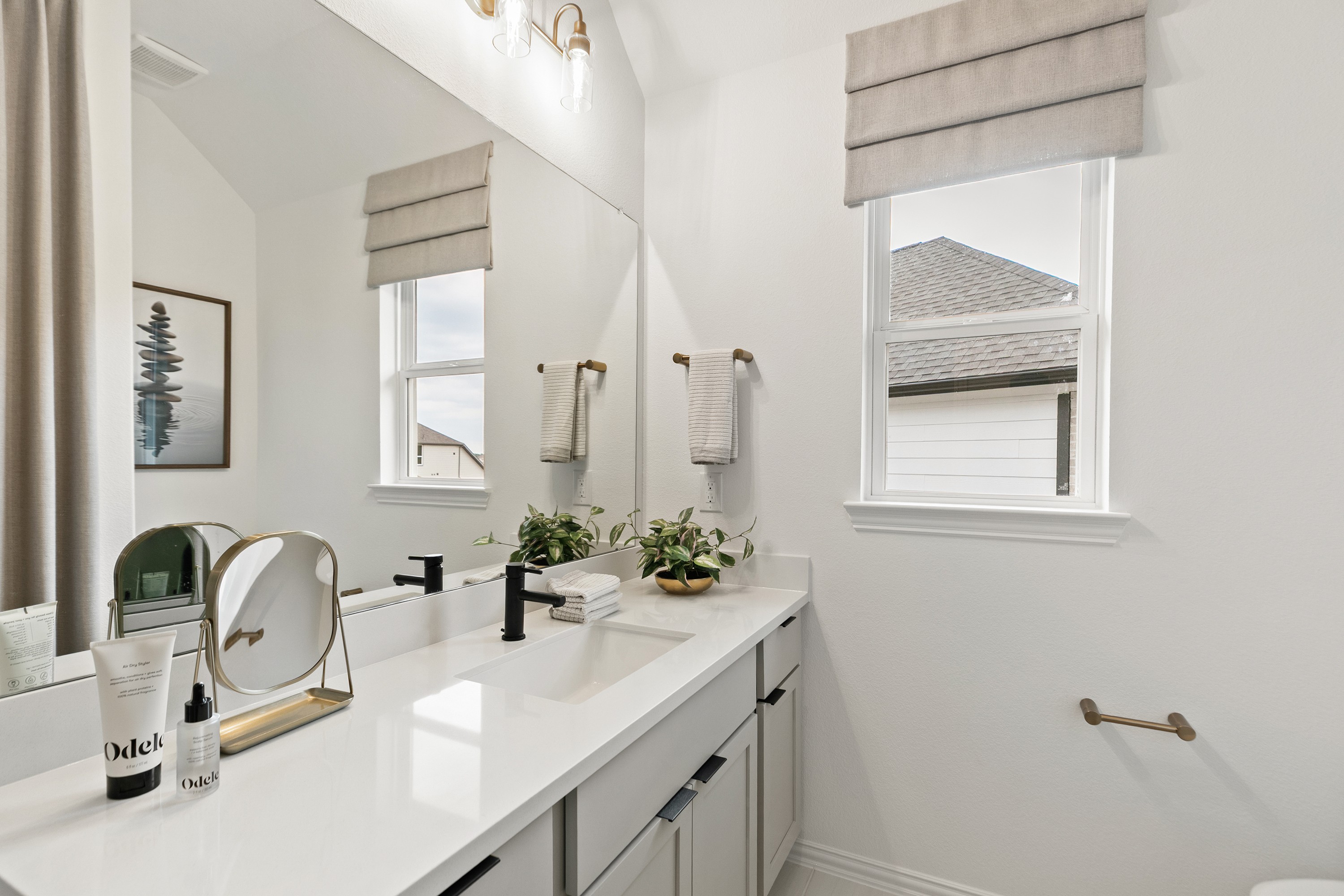 Modern Bathroom Design in Katy Lakes Luxury Home Elegant bathroom with dual sinks, modern fixtures, and natural light in Katy Lakes community.
