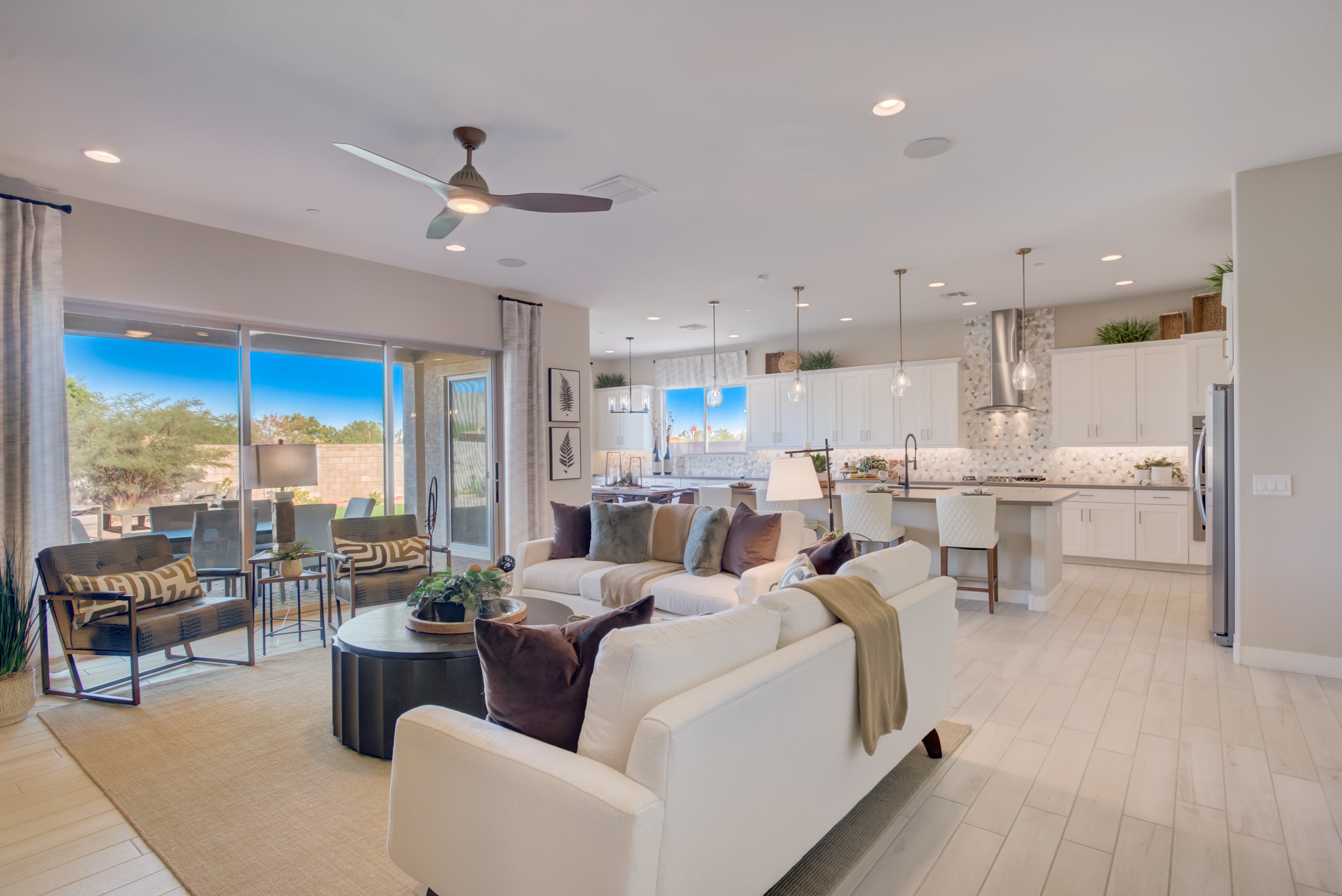 Spacious Open-Plan Living Room and Kitchen in Arroyo Seco Modern open-plan living room with kitchen, white cabinets, pendant lighting in Arroyo Seco - Palazzo community.