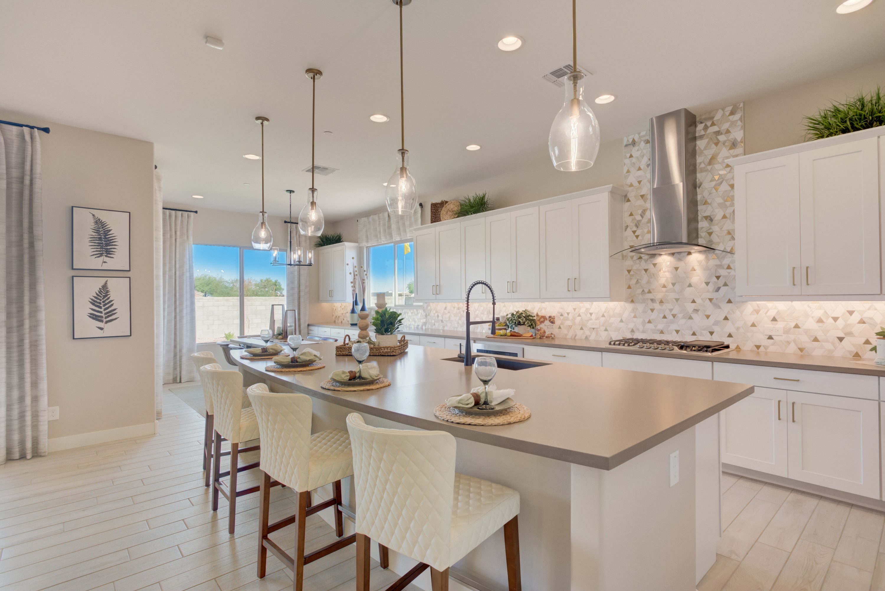 Luxury Kitchen with Island in Palazzo, Arroyo Seco Modern kitchen with island, pendant lights, white cabinetry, and geometric backsplash in Palazzo community, Arroyo Seco.