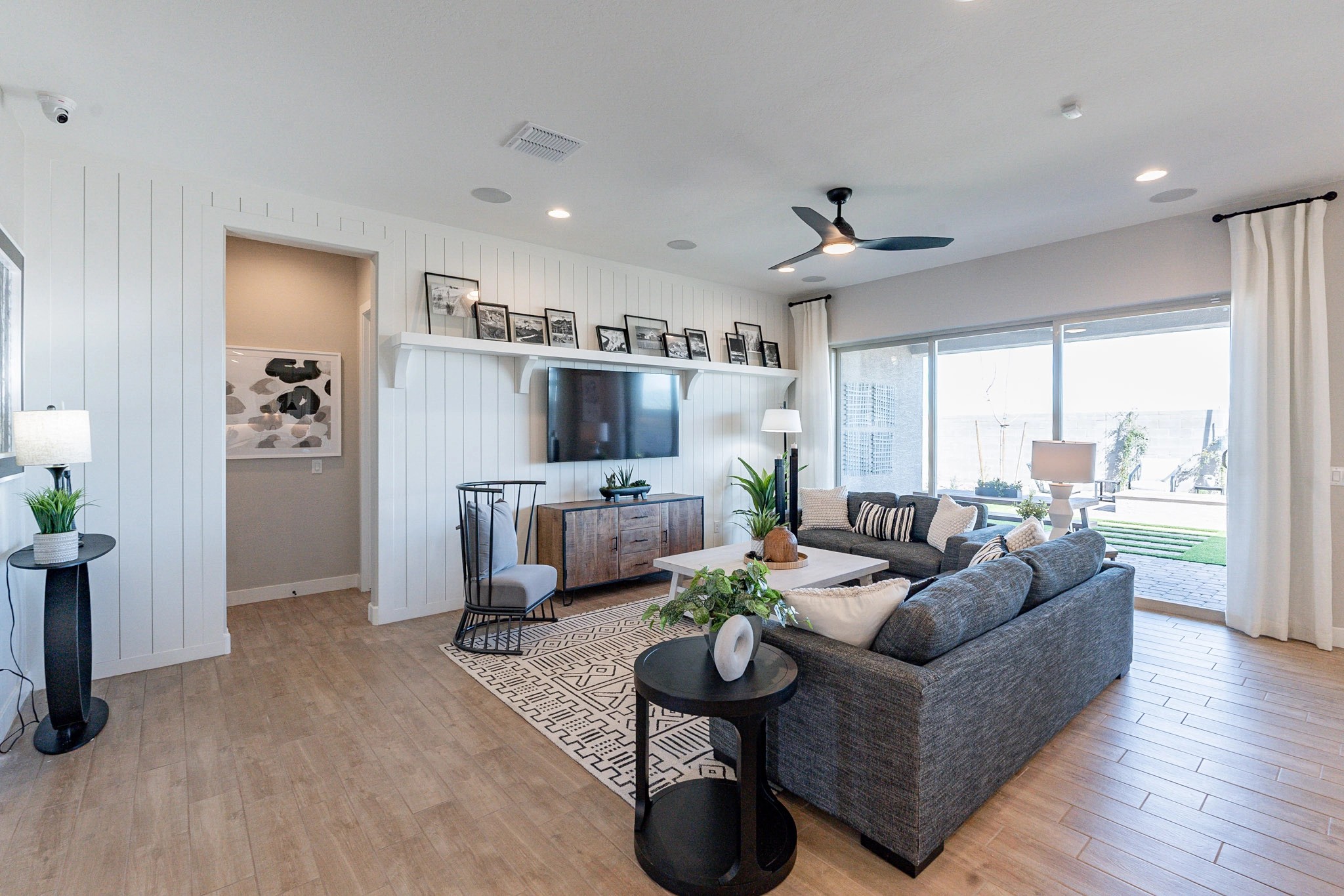 Arroyo Seco Hacienda Living Room with Shiplap and Large Window Modern living room with shiplap walls, wood floor, large window in Arroyo Seco Hacienda.